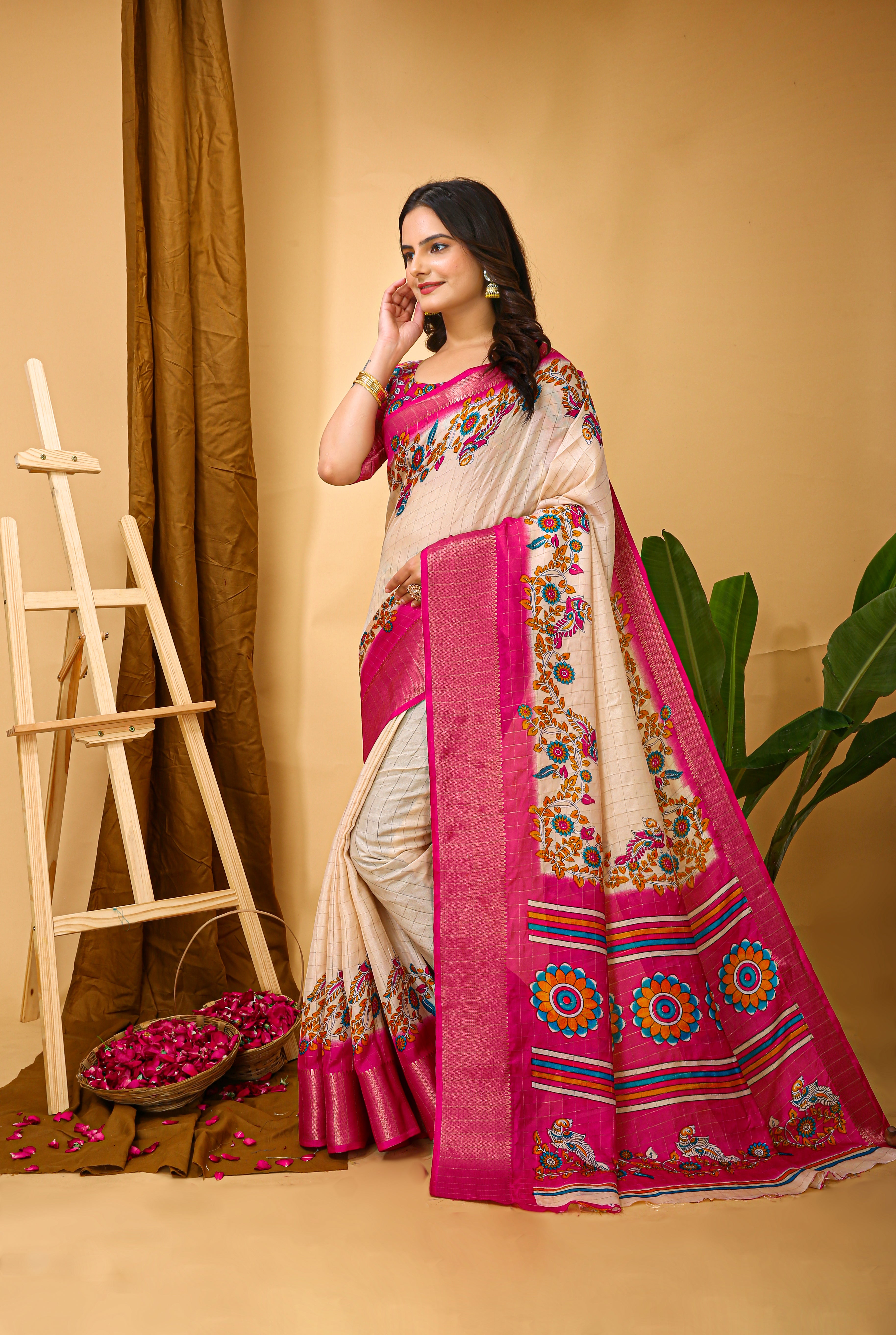 Woman wearing a traditional saree with a pink and white design against a beige background
