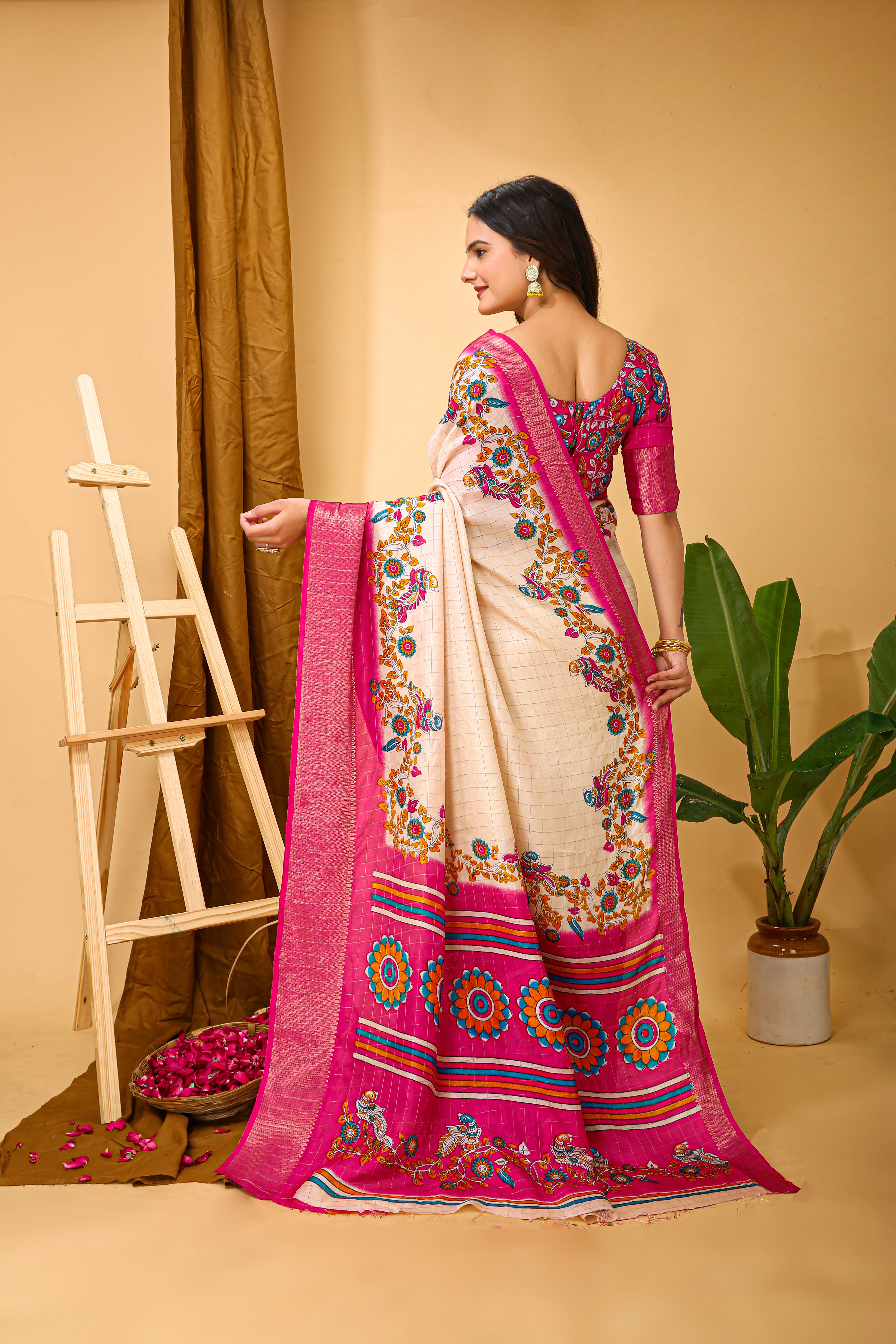 Woman wearing a traditional saree with floral patterns on a beige background