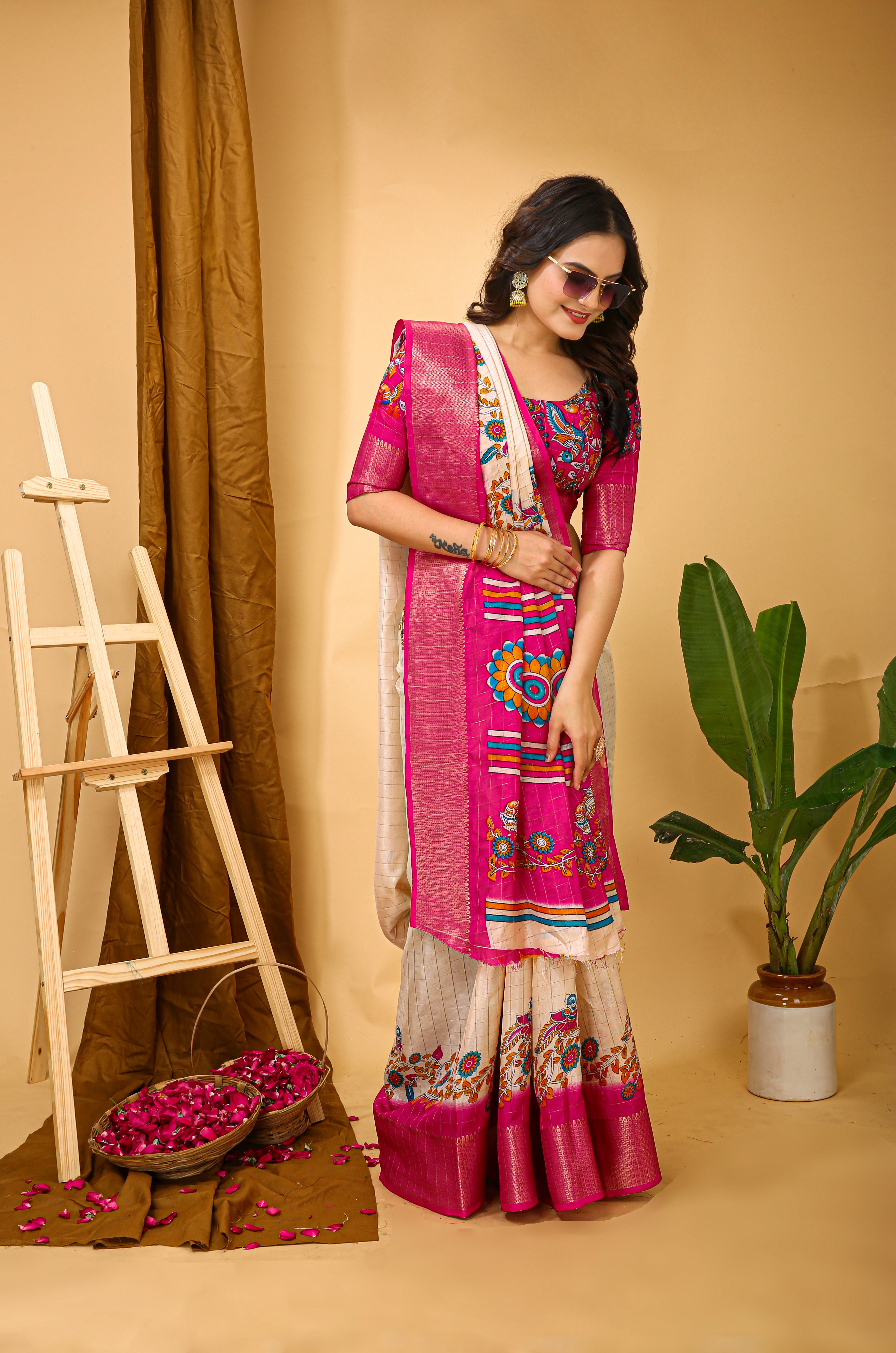 Woman in a pink and white traditional outfit with floral patterns on a beige background