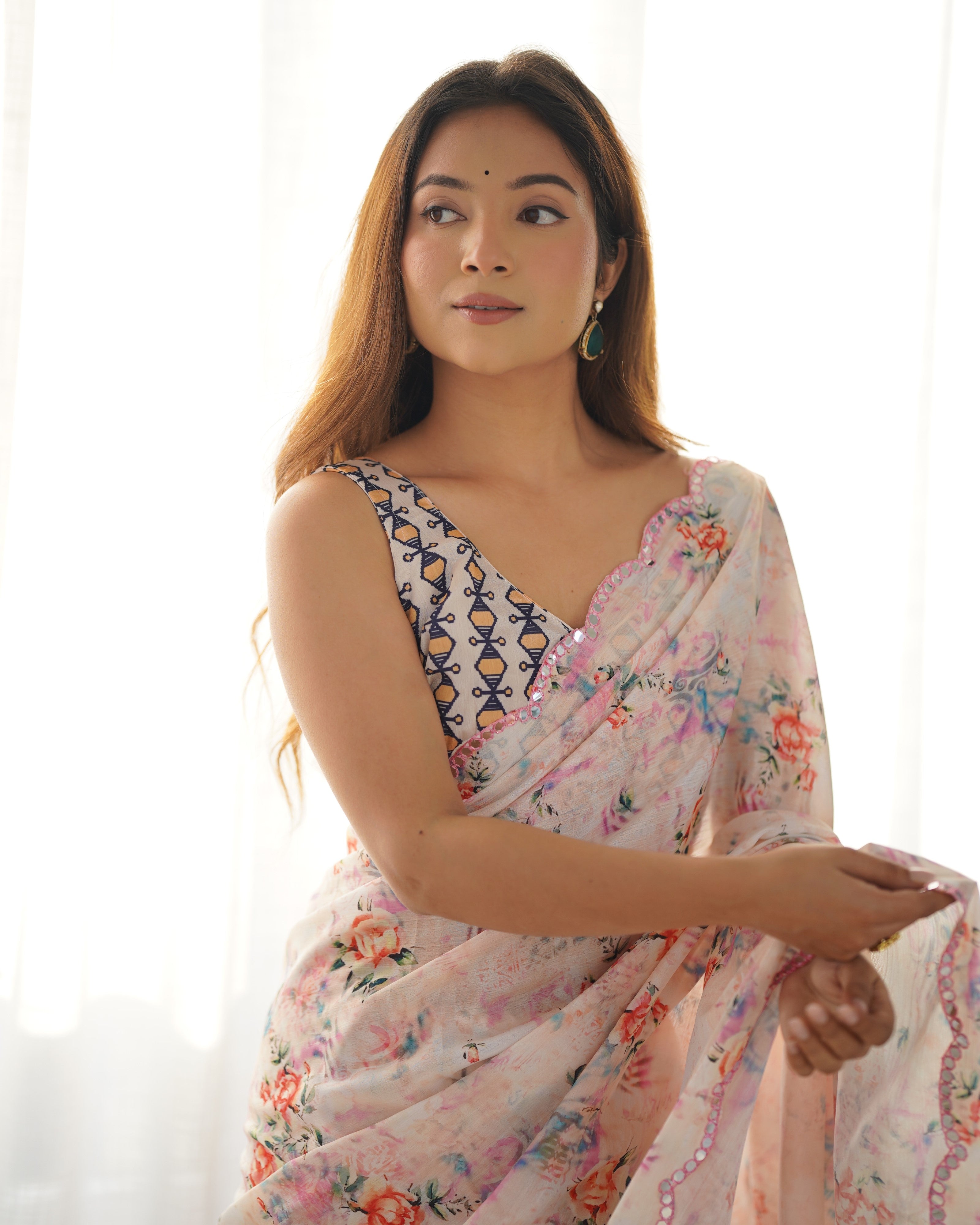 Woman wearing a floral saree with a white background