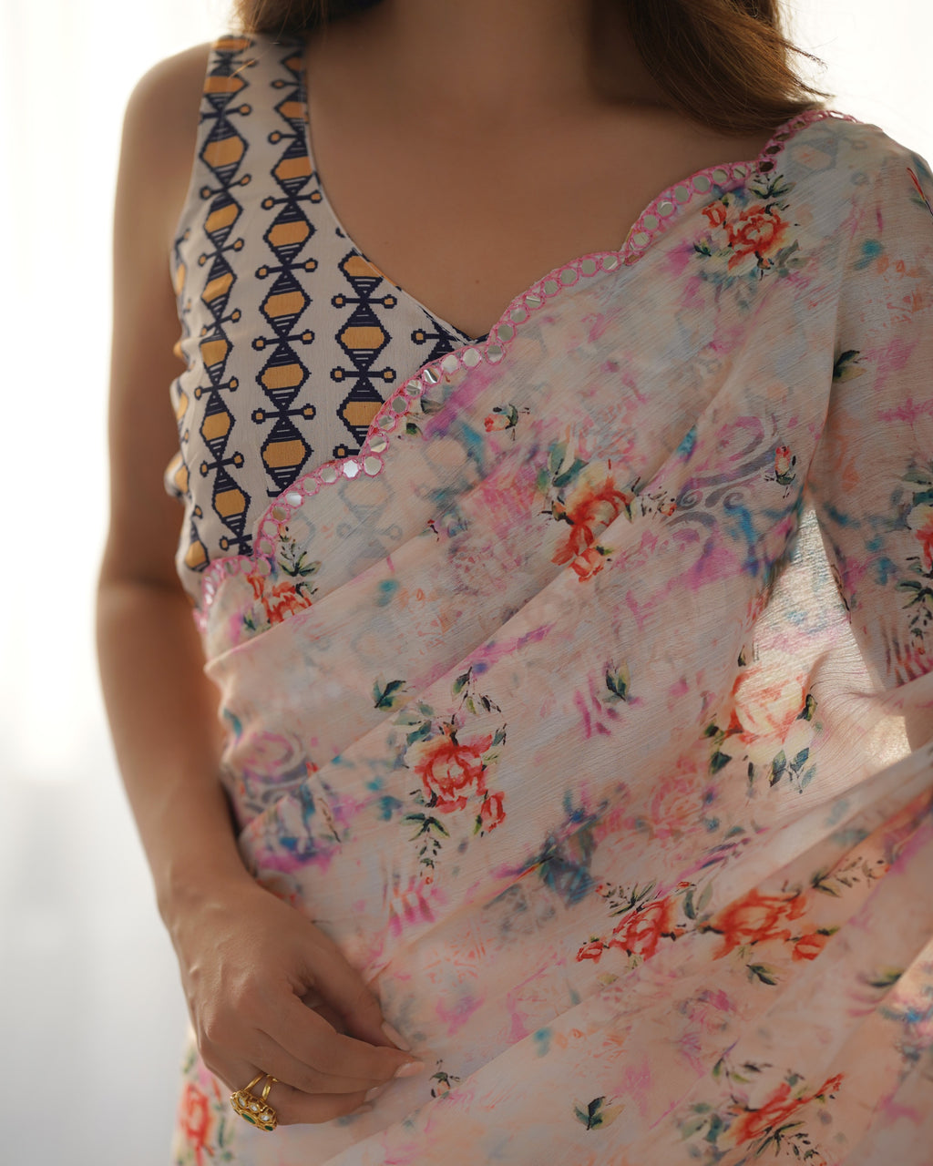 Floral saree with a patterned blouse on a white background