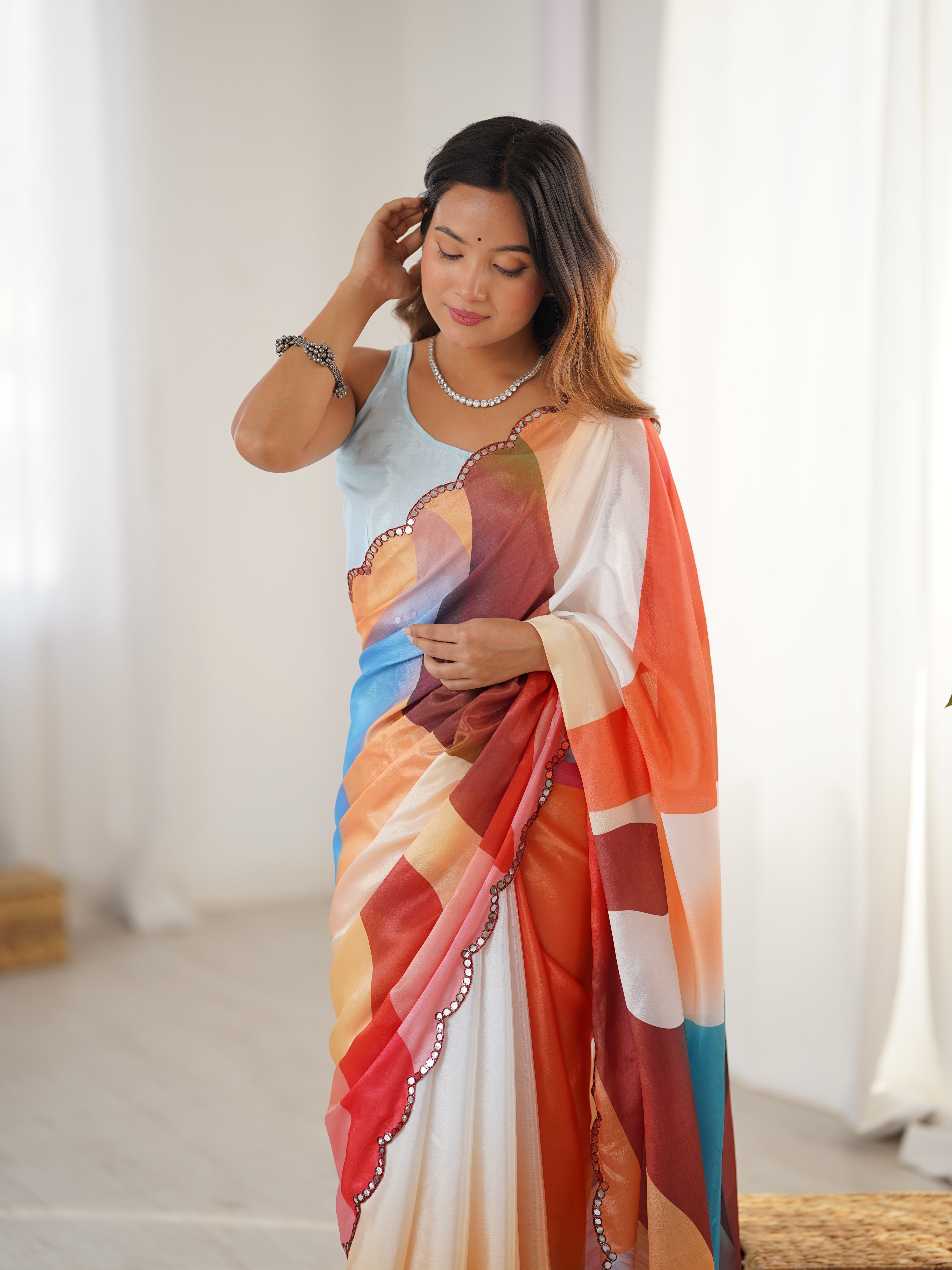 Woman wearing a colorful saree with a white background
