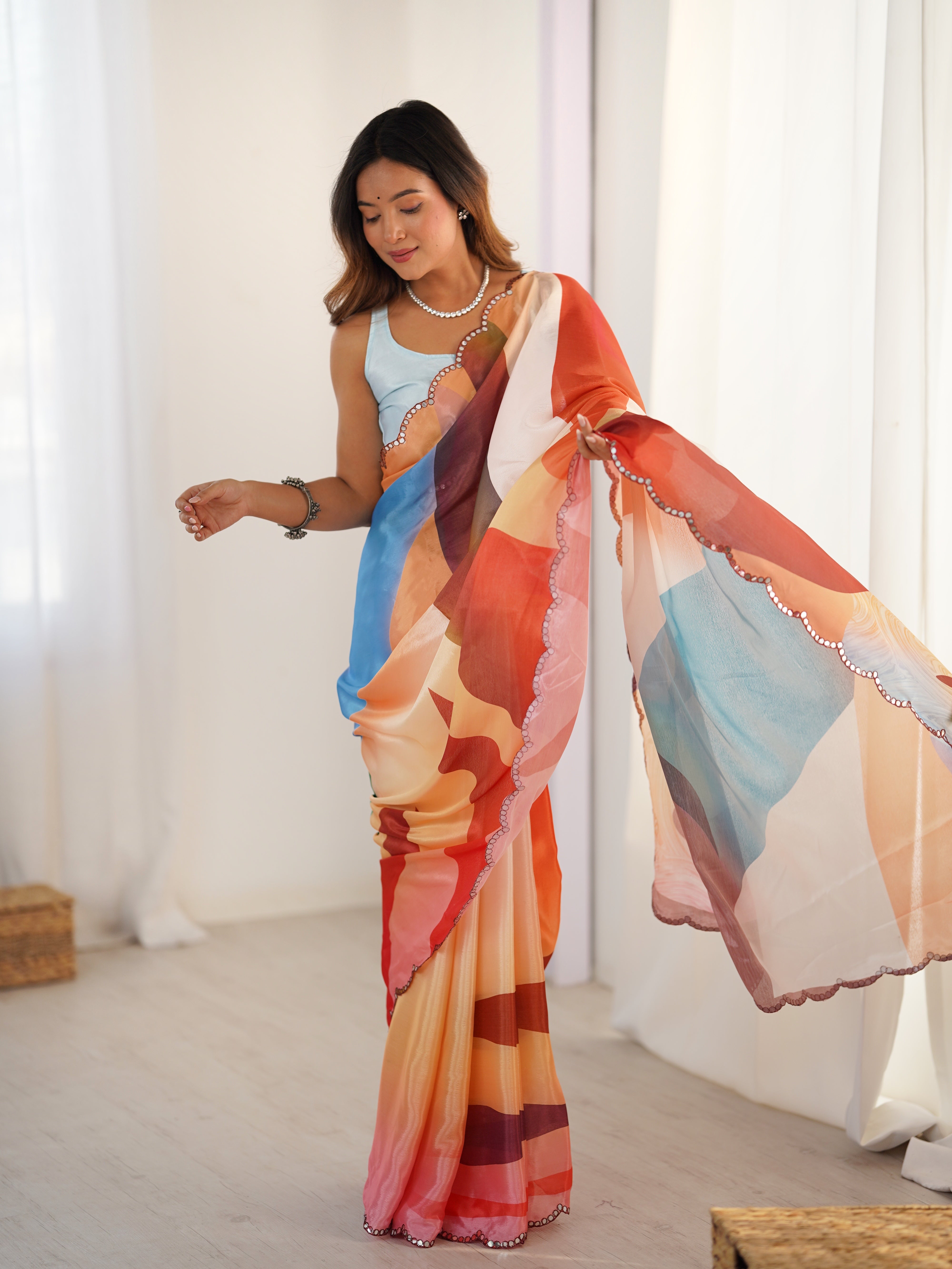 Woman holding a colorful scarf in a bright room