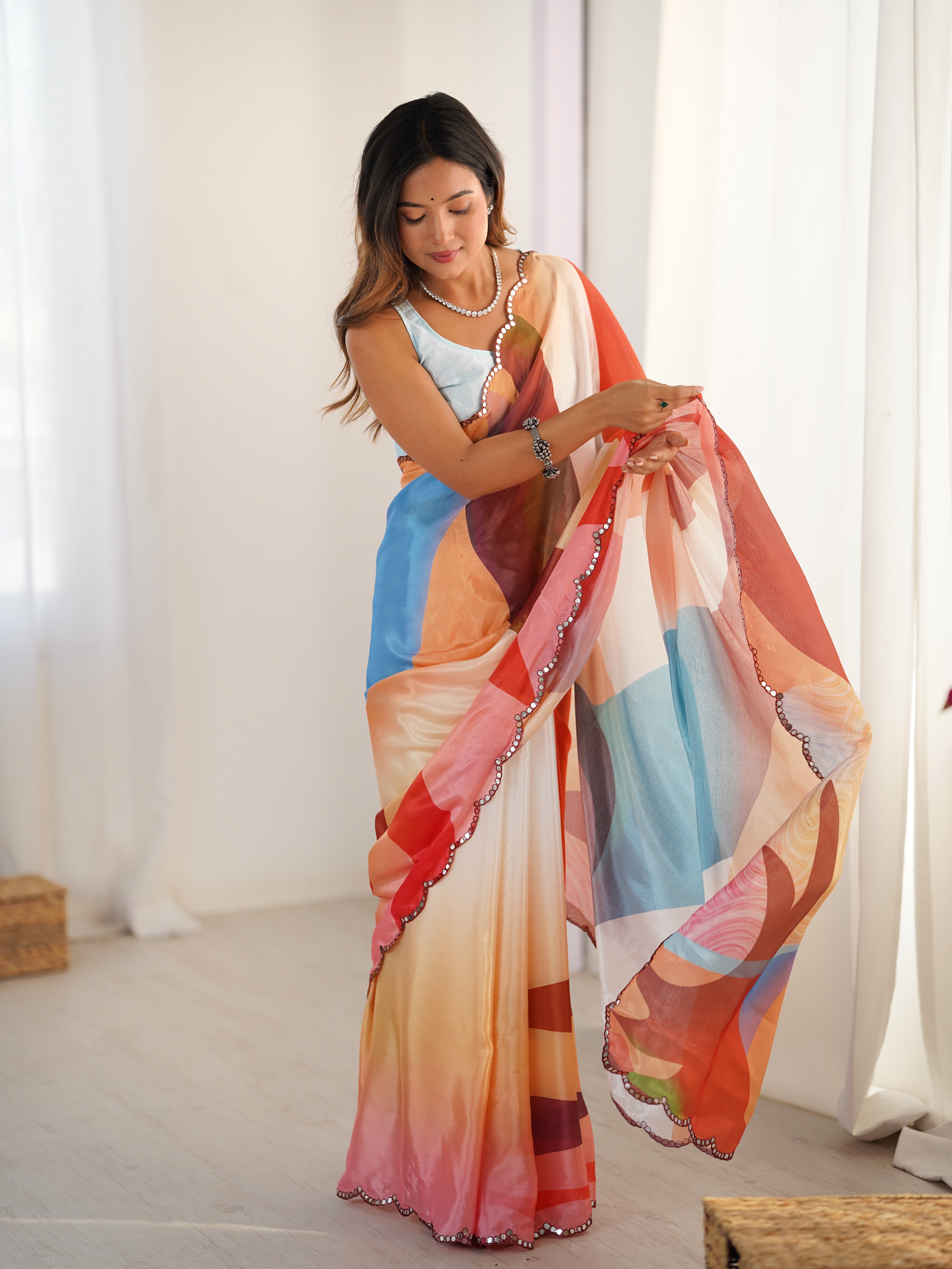 Woman holding a colorful scarf in a bright room