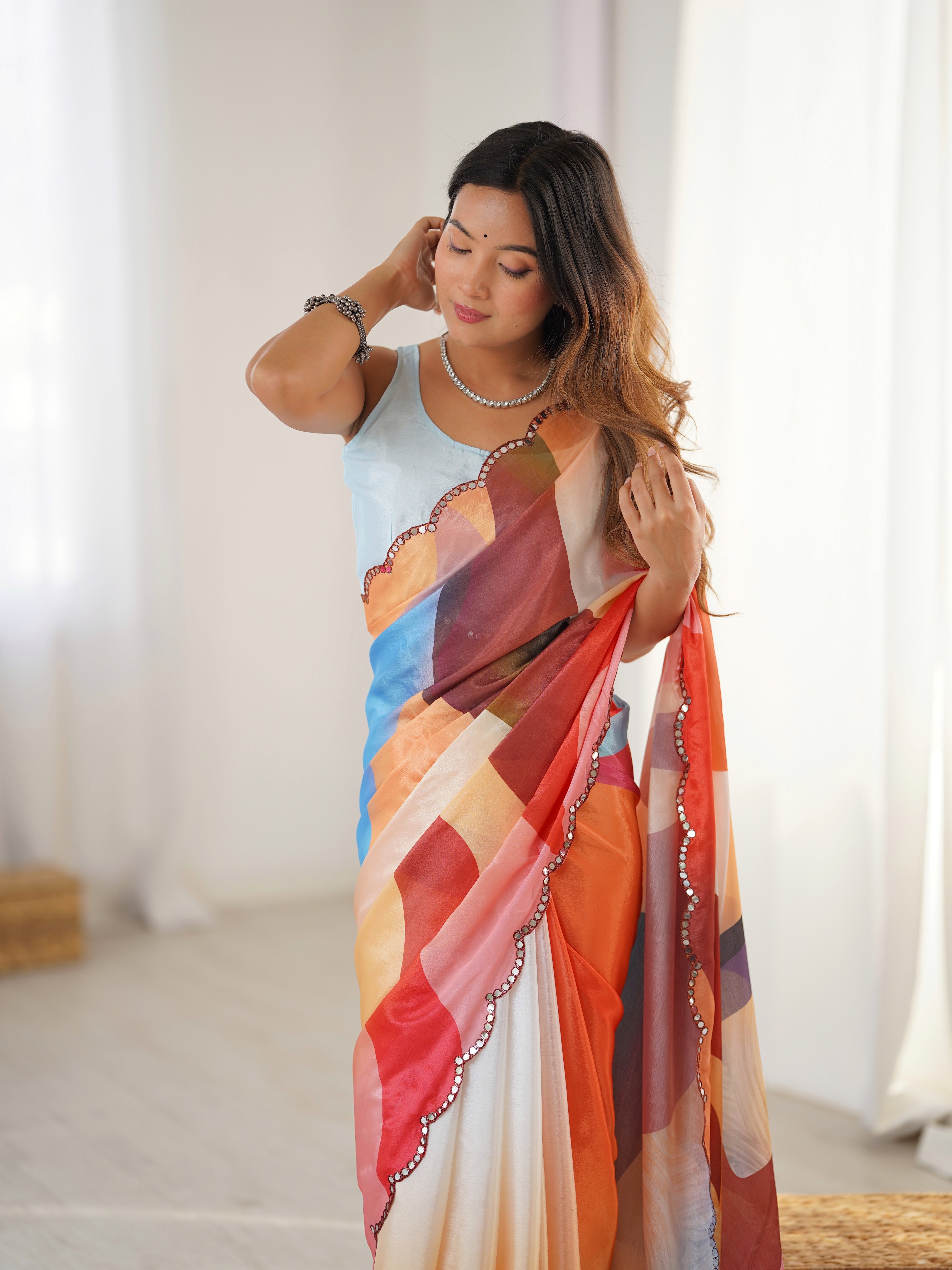 Woman holding a colorful scarf with a neutral background