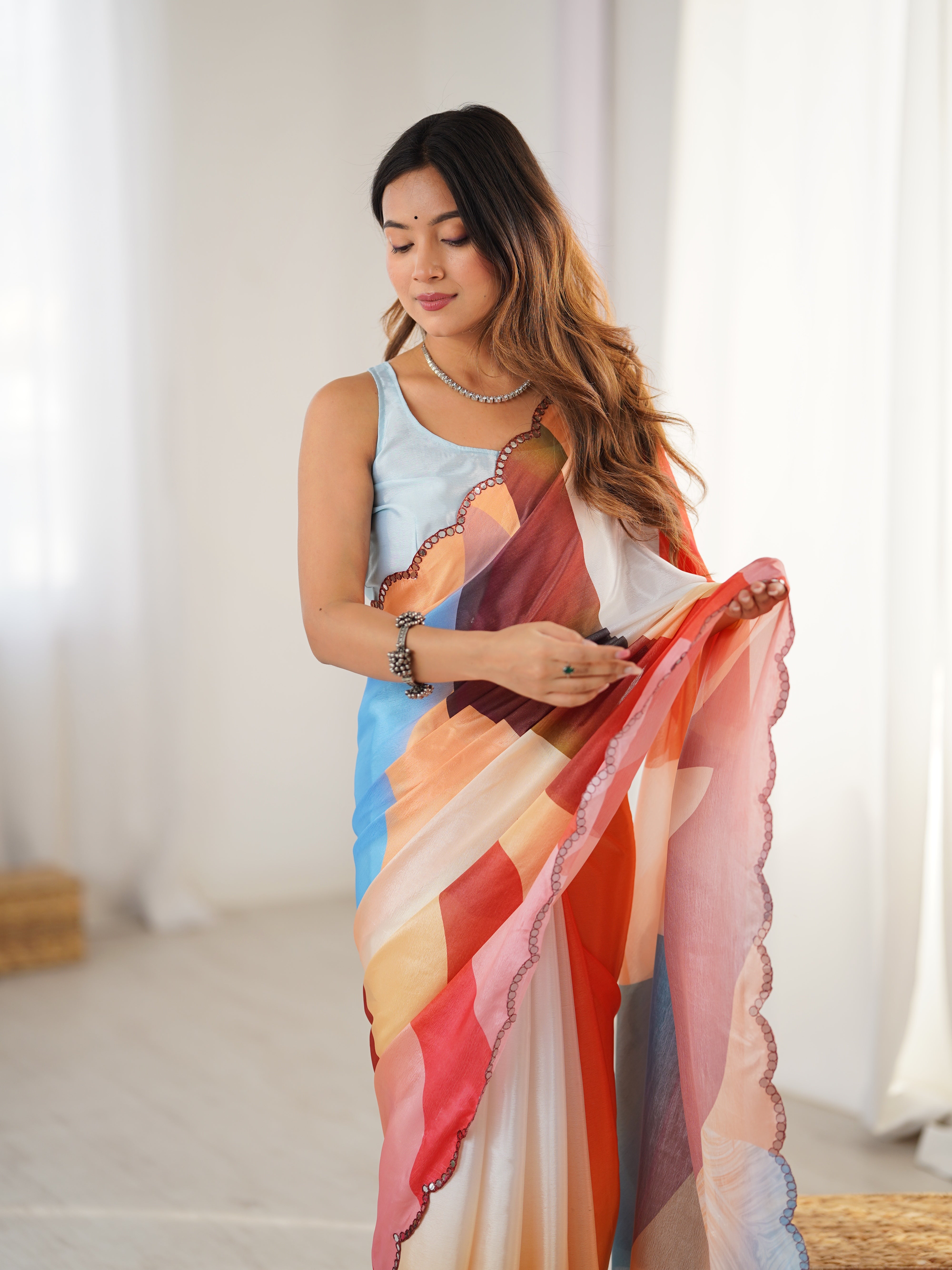 Woman holding a colorful scarf in a bright room