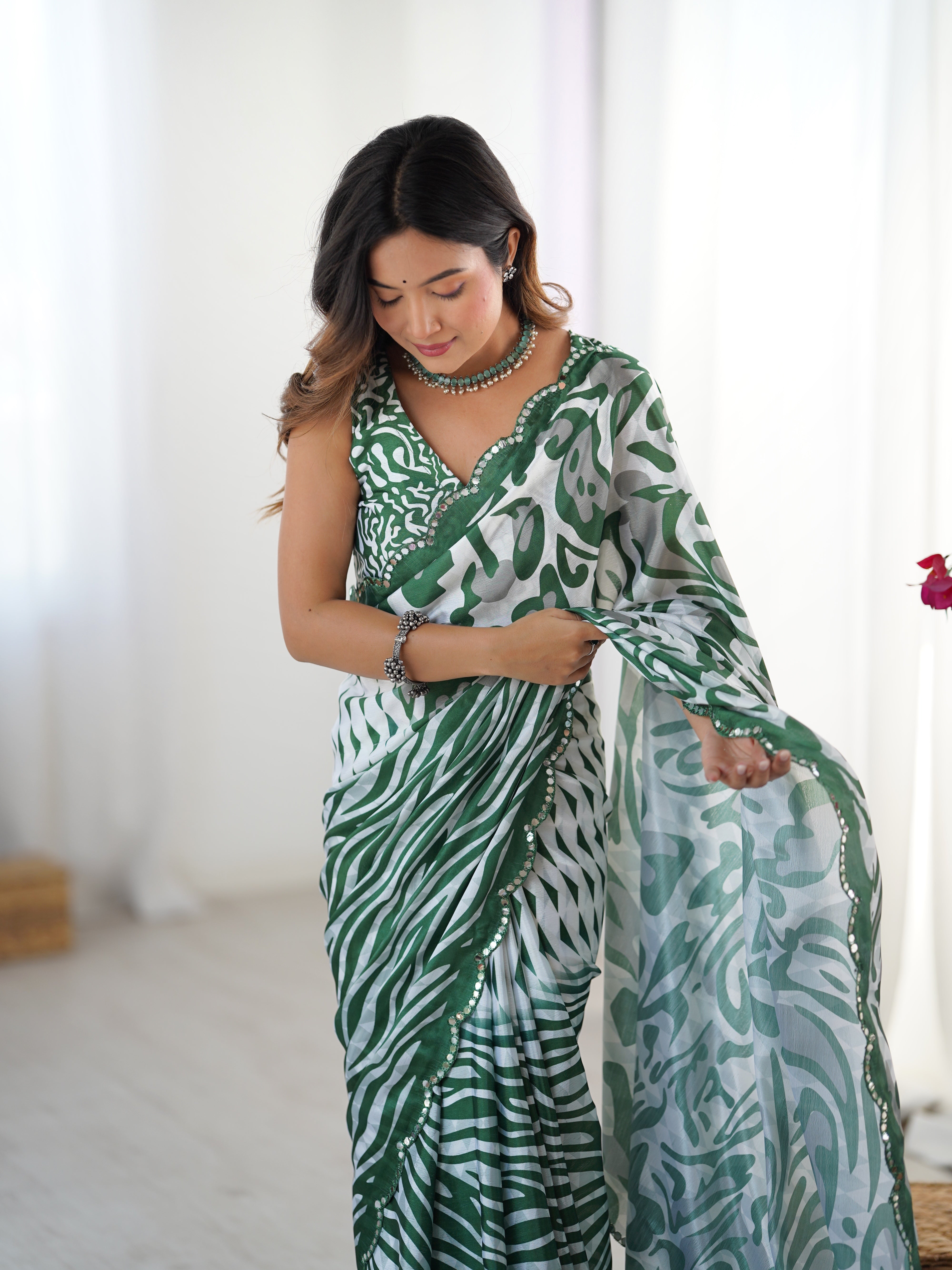 Woman wearing a green and white patterned outfit with a plain background