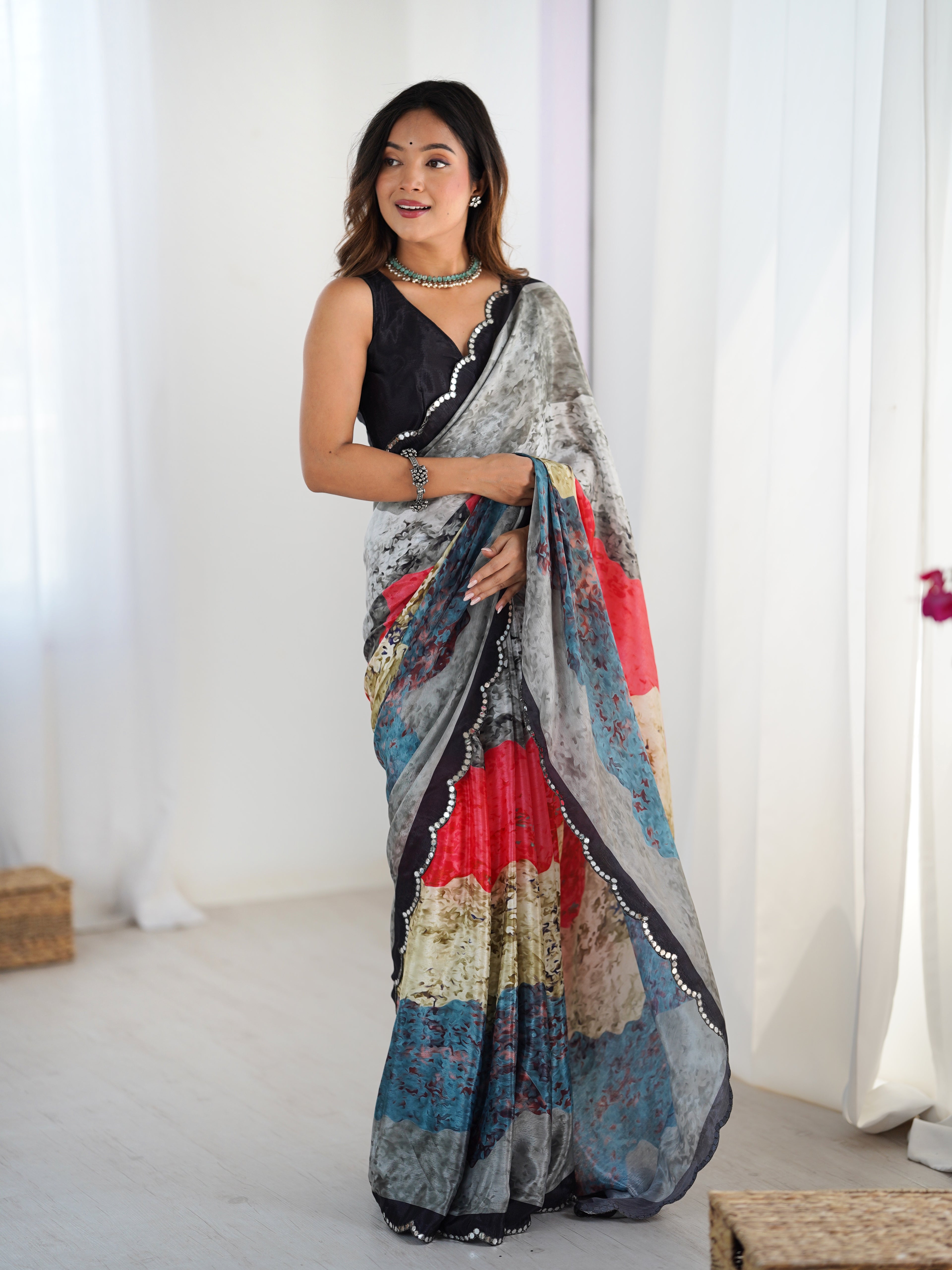 Woman wearing a colorful saree with a white background