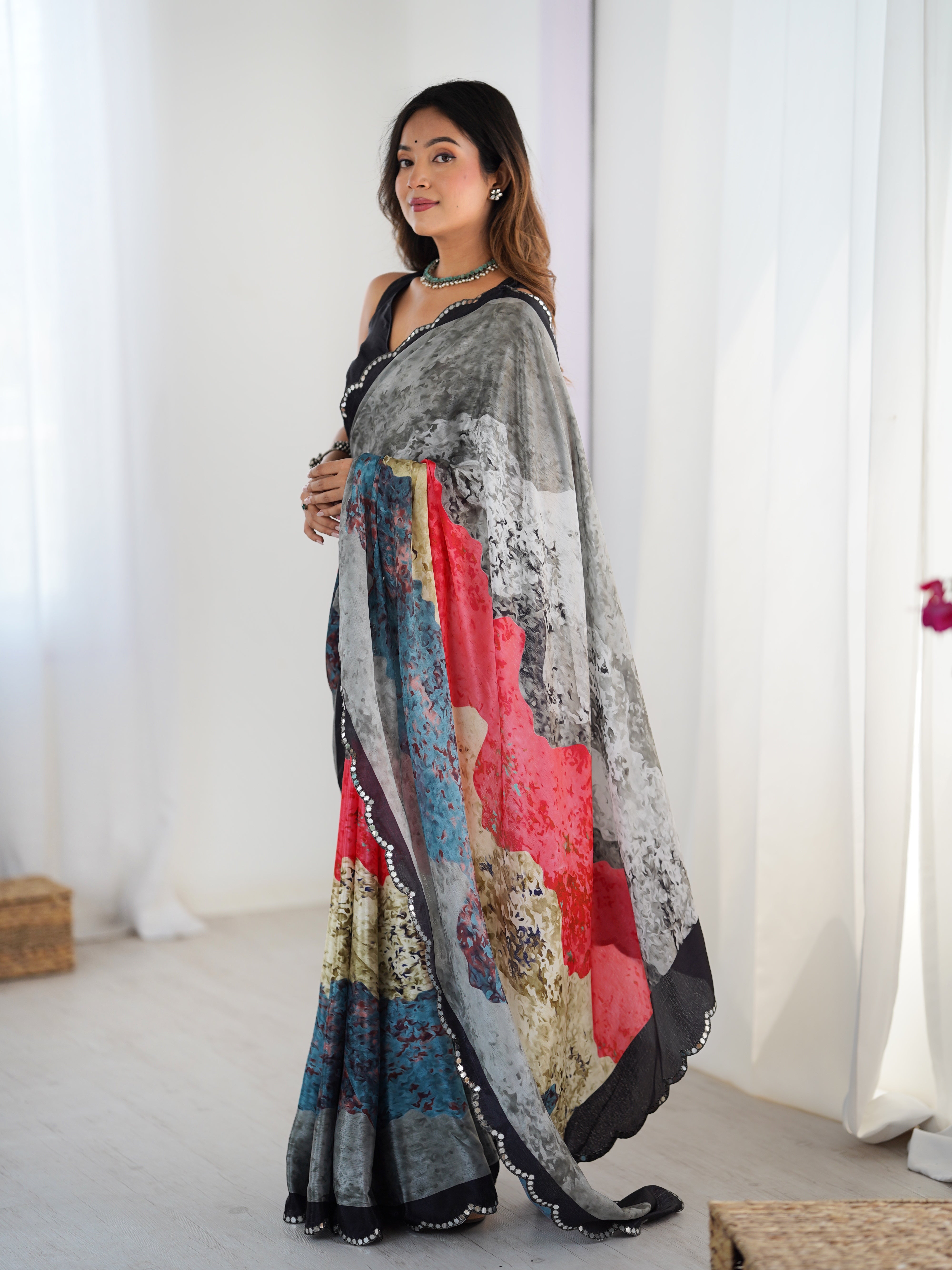 Woman wearing a colorful saree with a white background