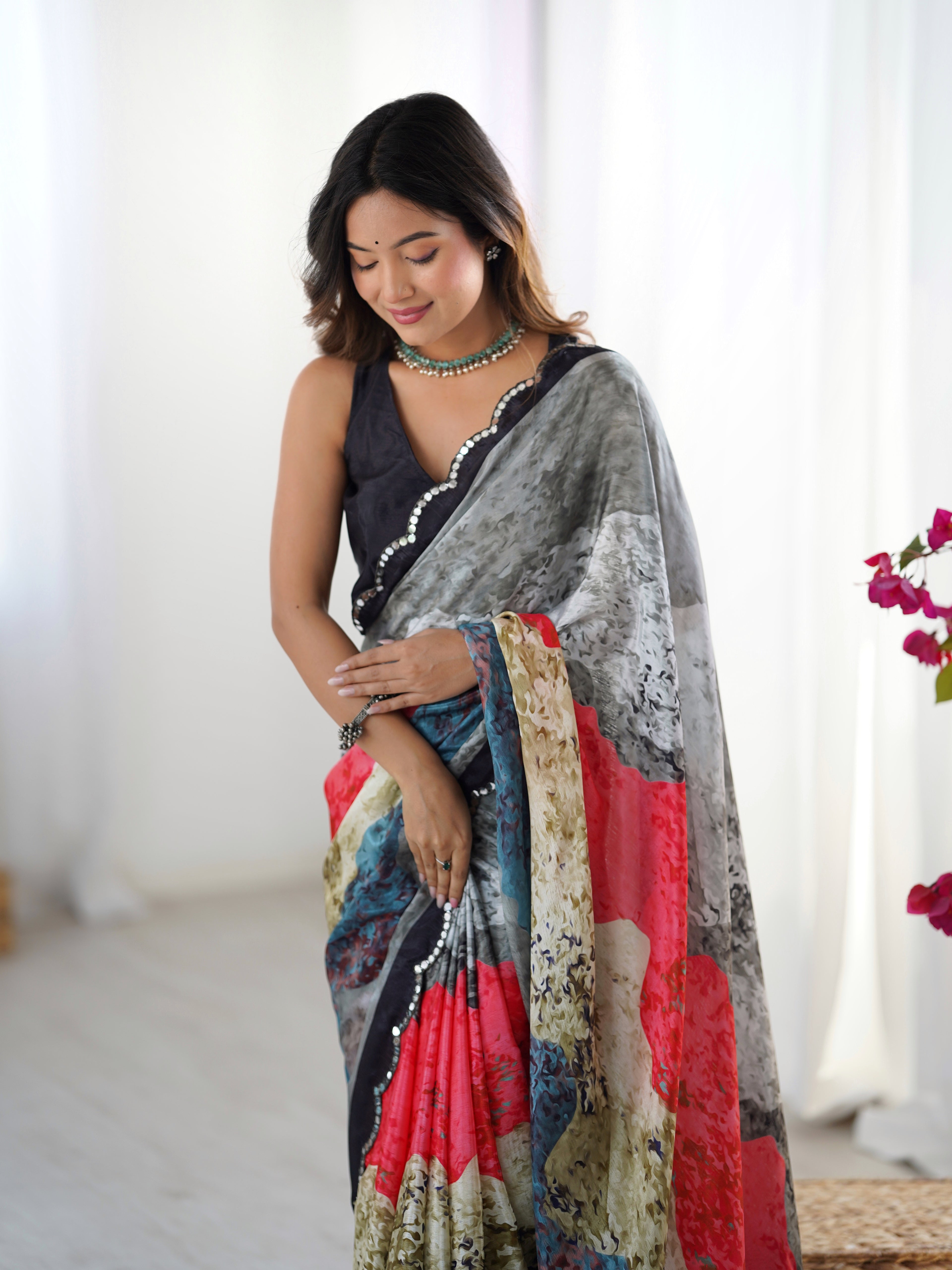 Woman wearing a colorful saree with a neutral background