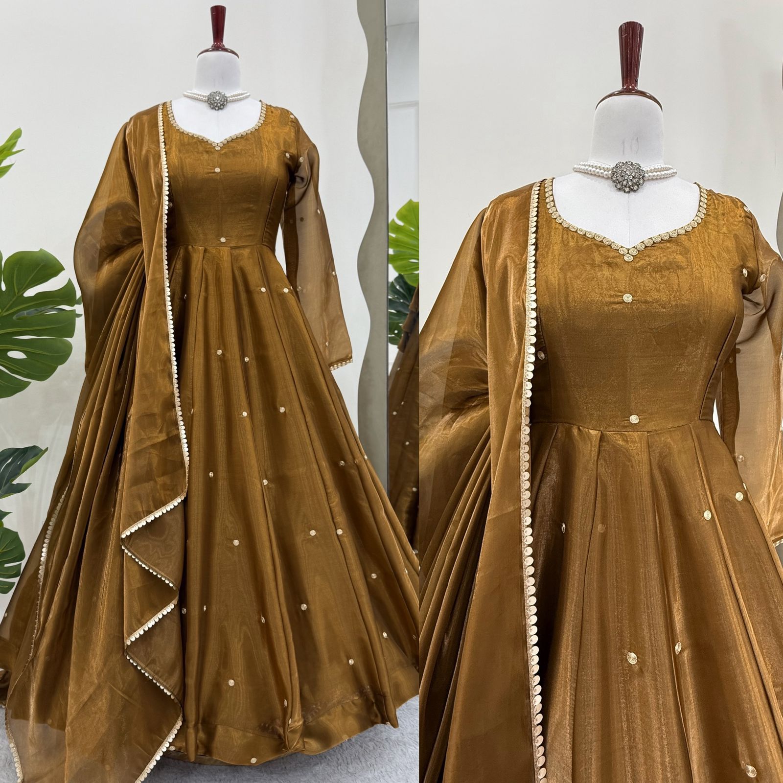 Brown Anarkali gown or dress with sheer sleeves on a mannequin against a white background