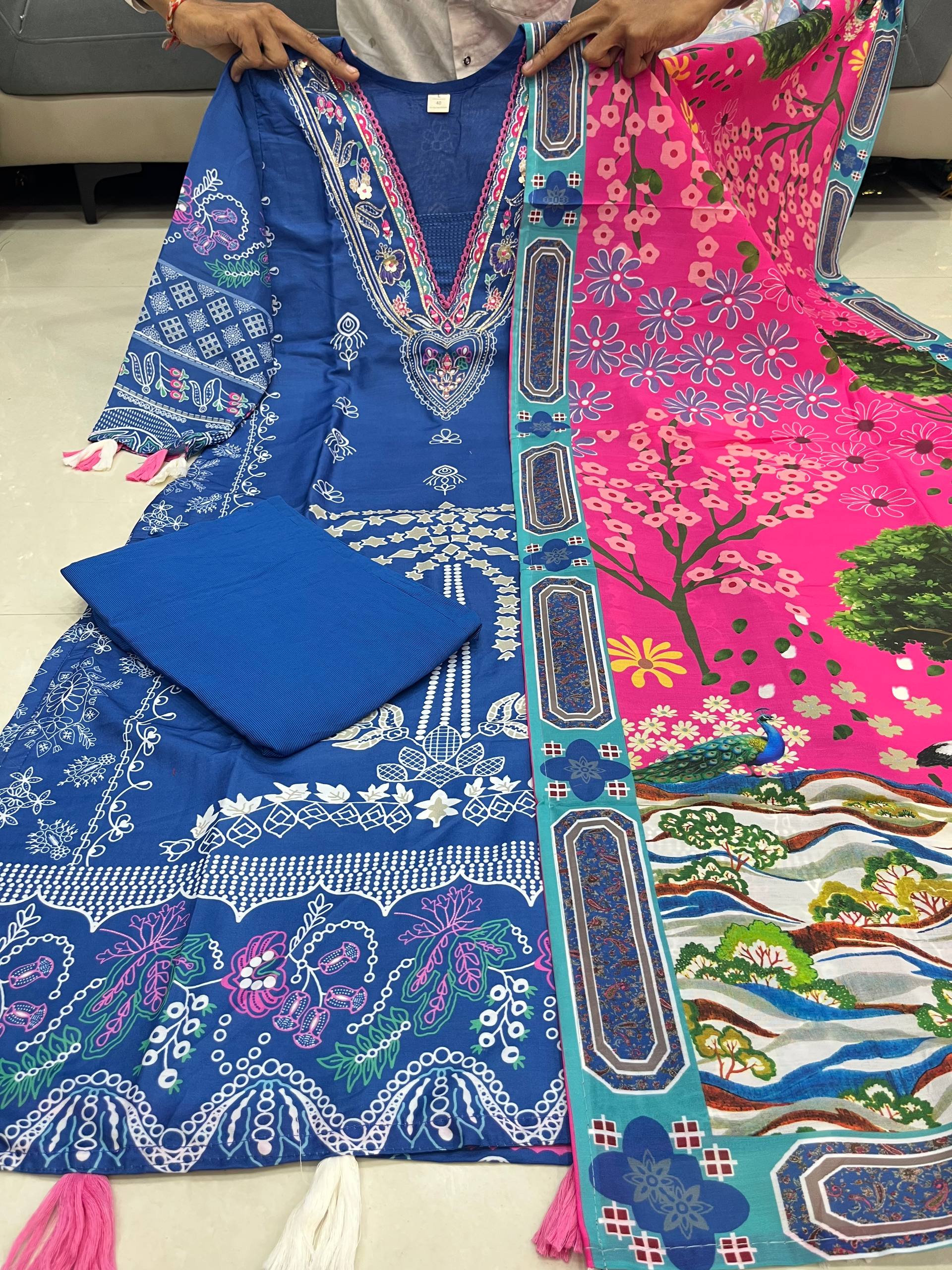 Two pieces of fabric with intricate patterns, one blue and one pink, laid out on a flat surface.