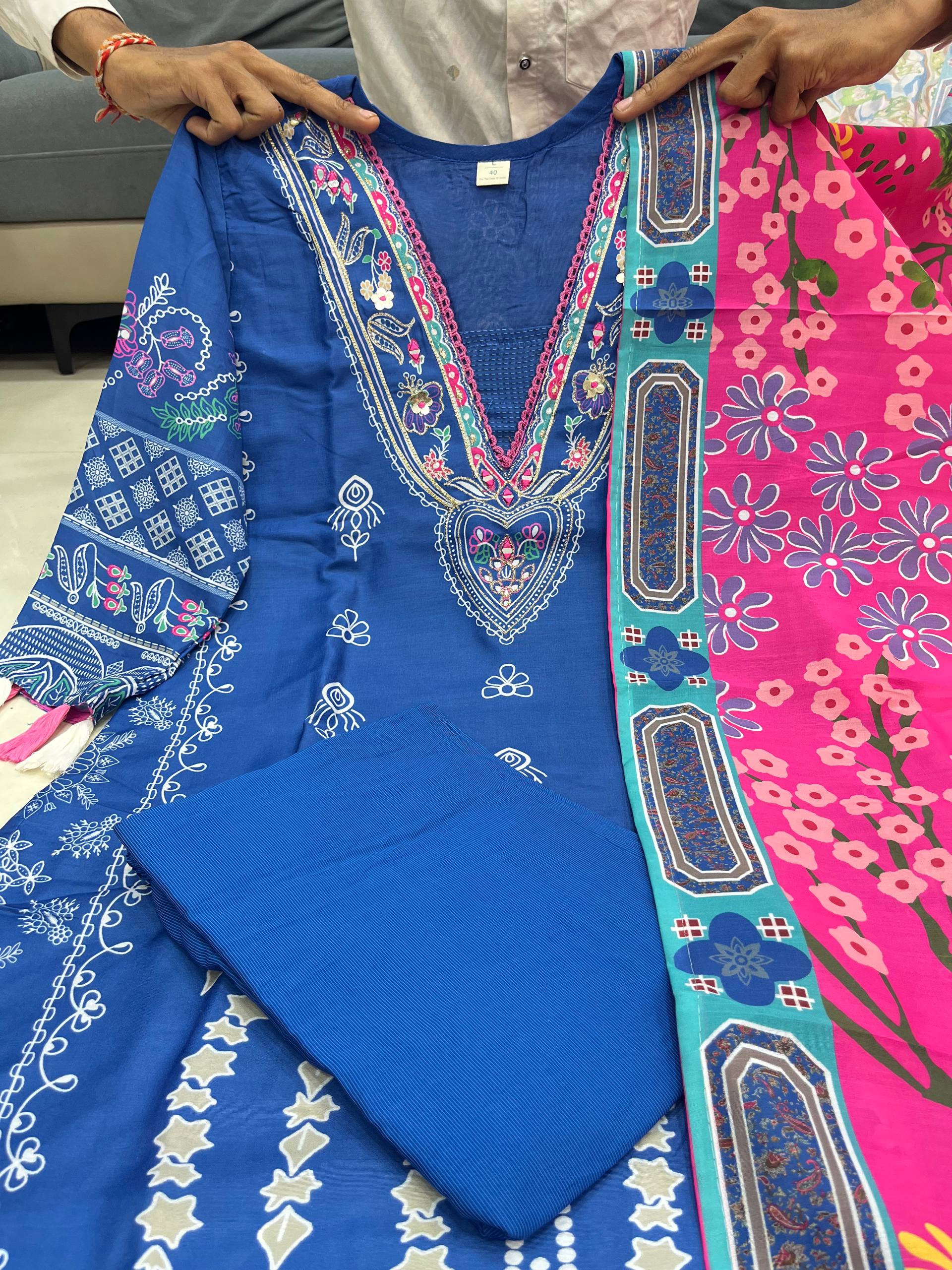 Blue digital printed outfit with colorful patterns on a pink and green dupatta.