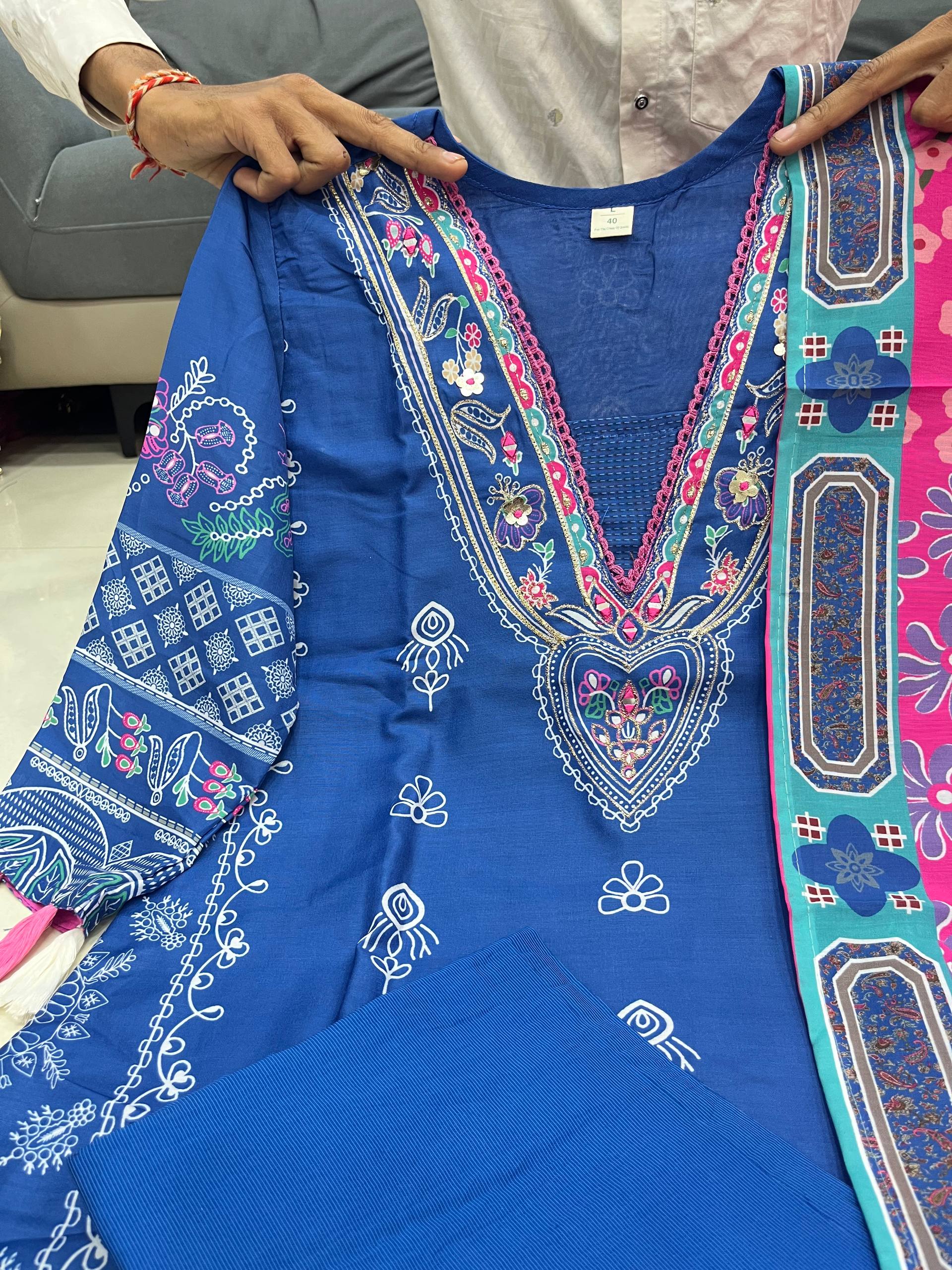 Blue digital printed kurta set dress held by a person indoors