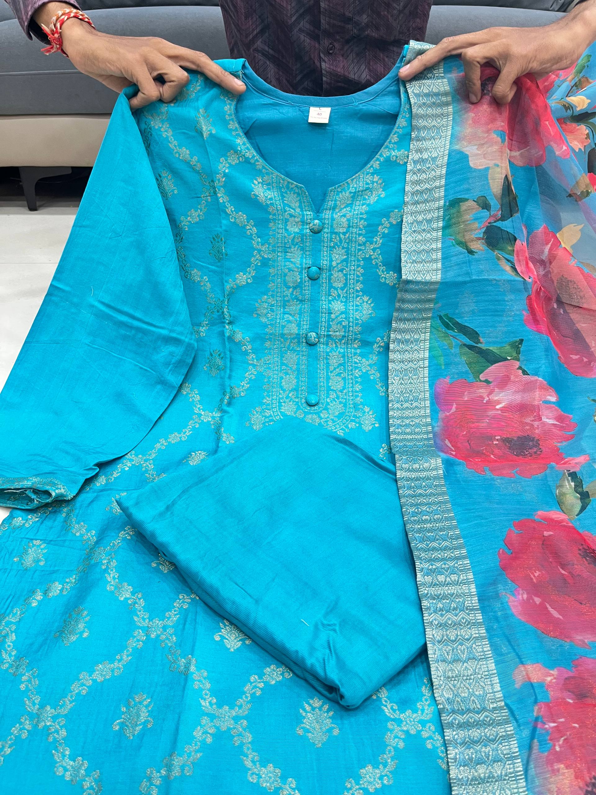 Blue kurta set outfit with a floral pink and green dupatta held by hands.