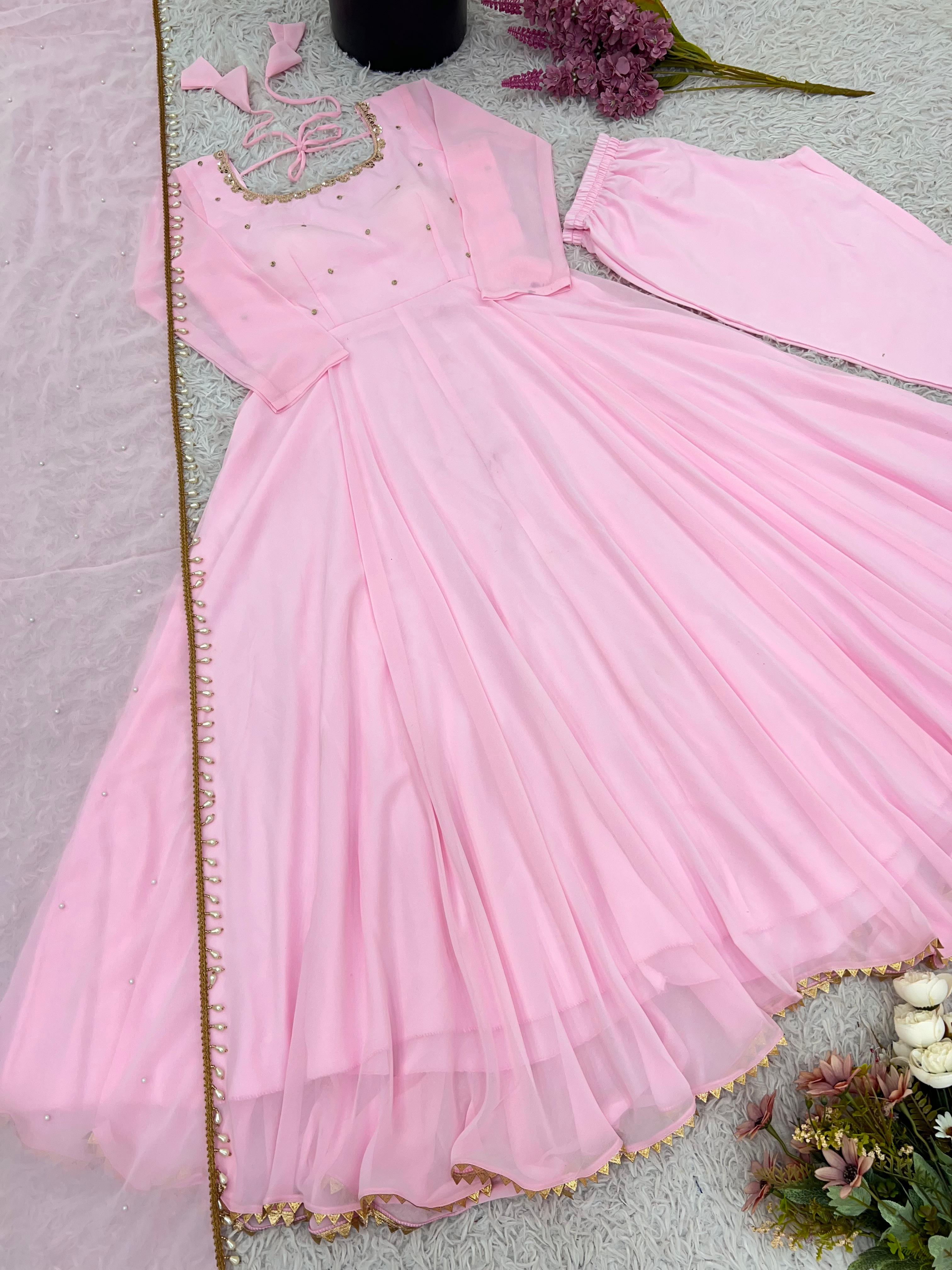 Pink dress with floral decorations on a light pink background
