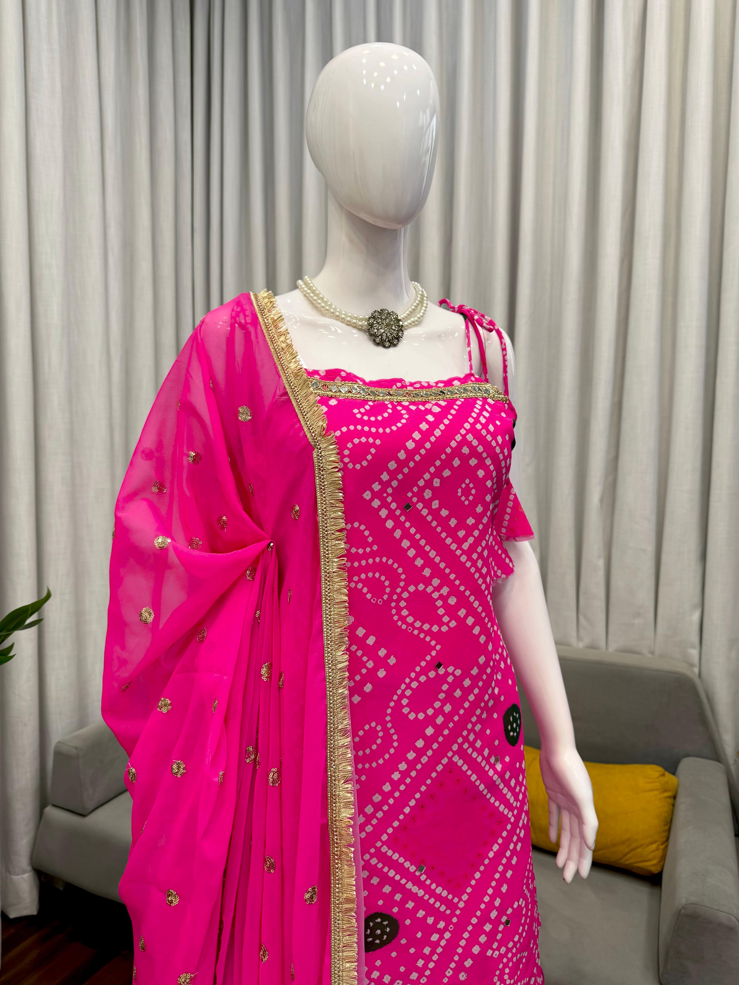 Mannequin wearing a bright pink sharara set with a patterned design against a neutral background