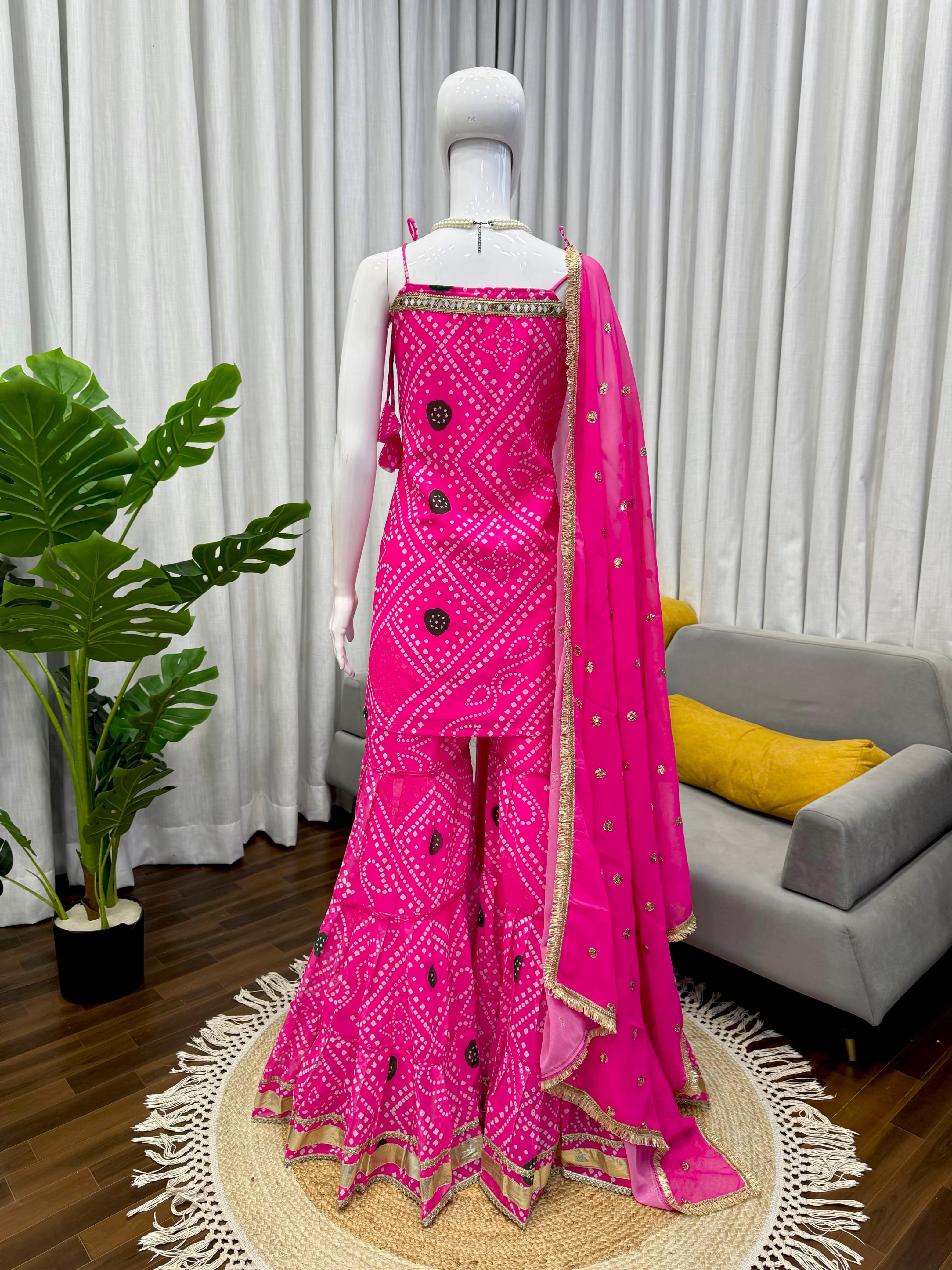Pink traditional outfit with a matching dupatta on a mannequin against a neutral background