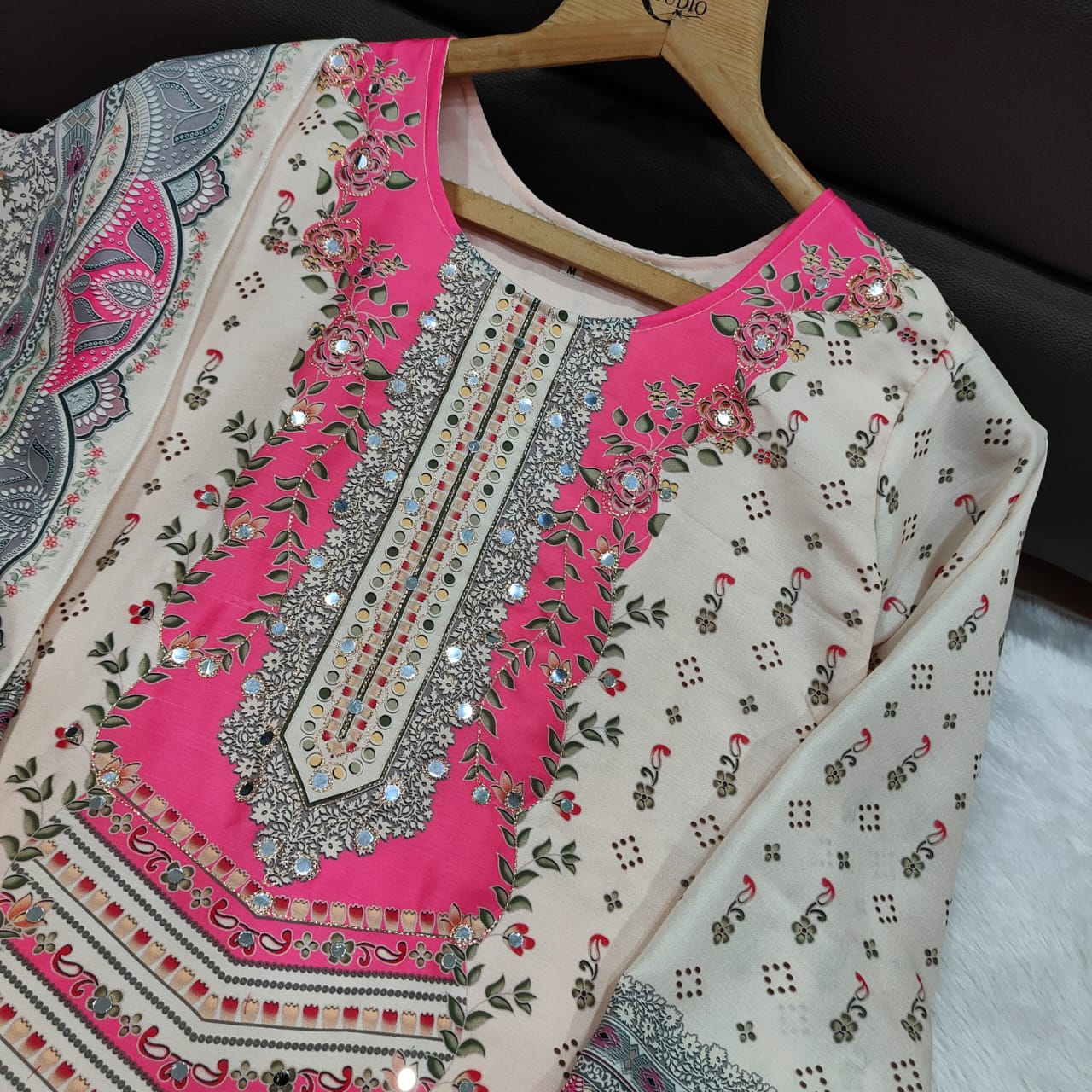 Decorative fabric with pink and gray patterns on a hanger