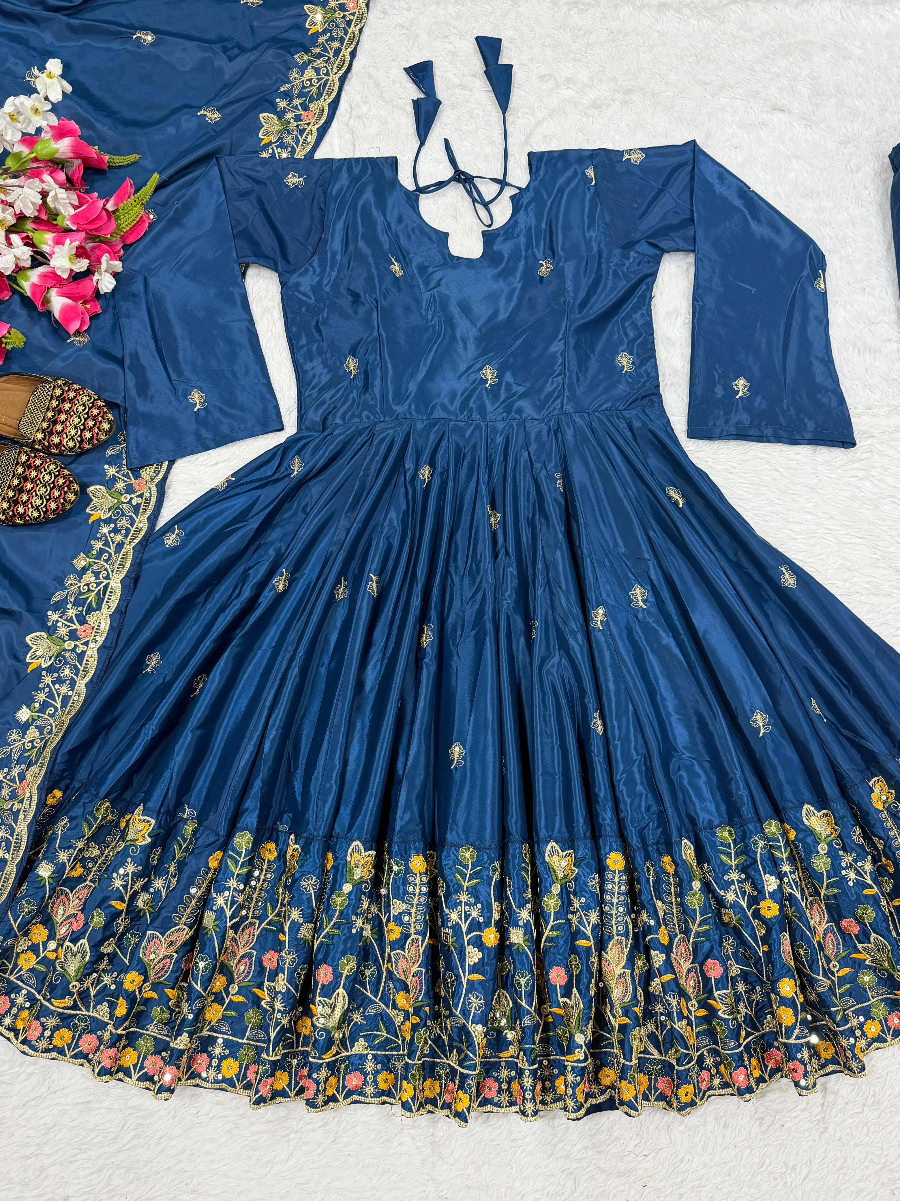 Blue embroidered dress with floral patterns on a white background