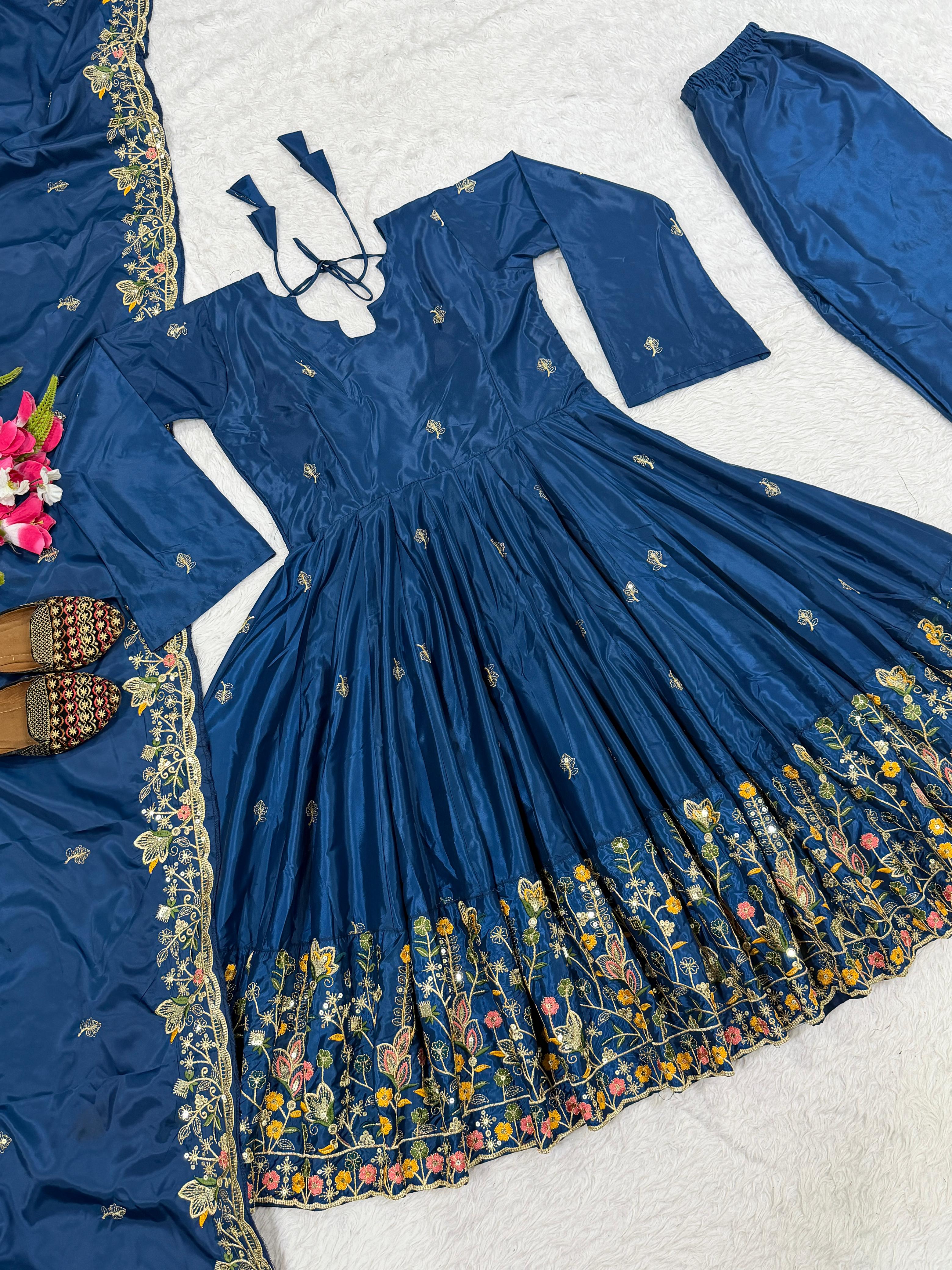 Blue traditional outfit with floral patterns on a white background