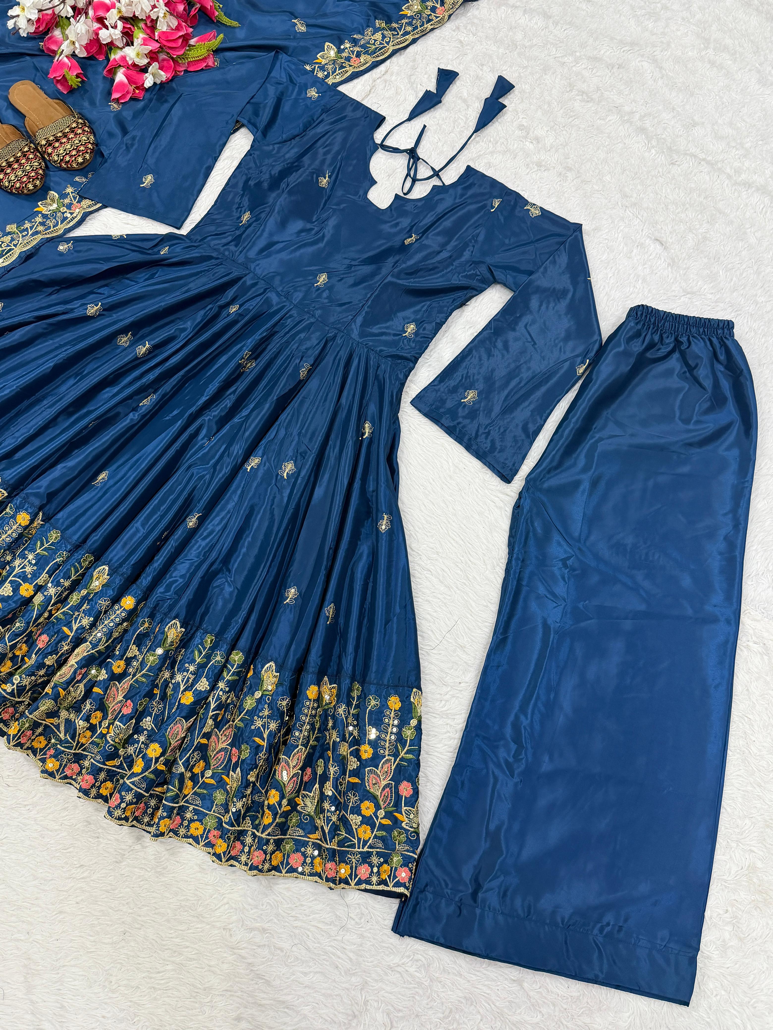 Blue traditional outfit with floral patterns on a textured surface