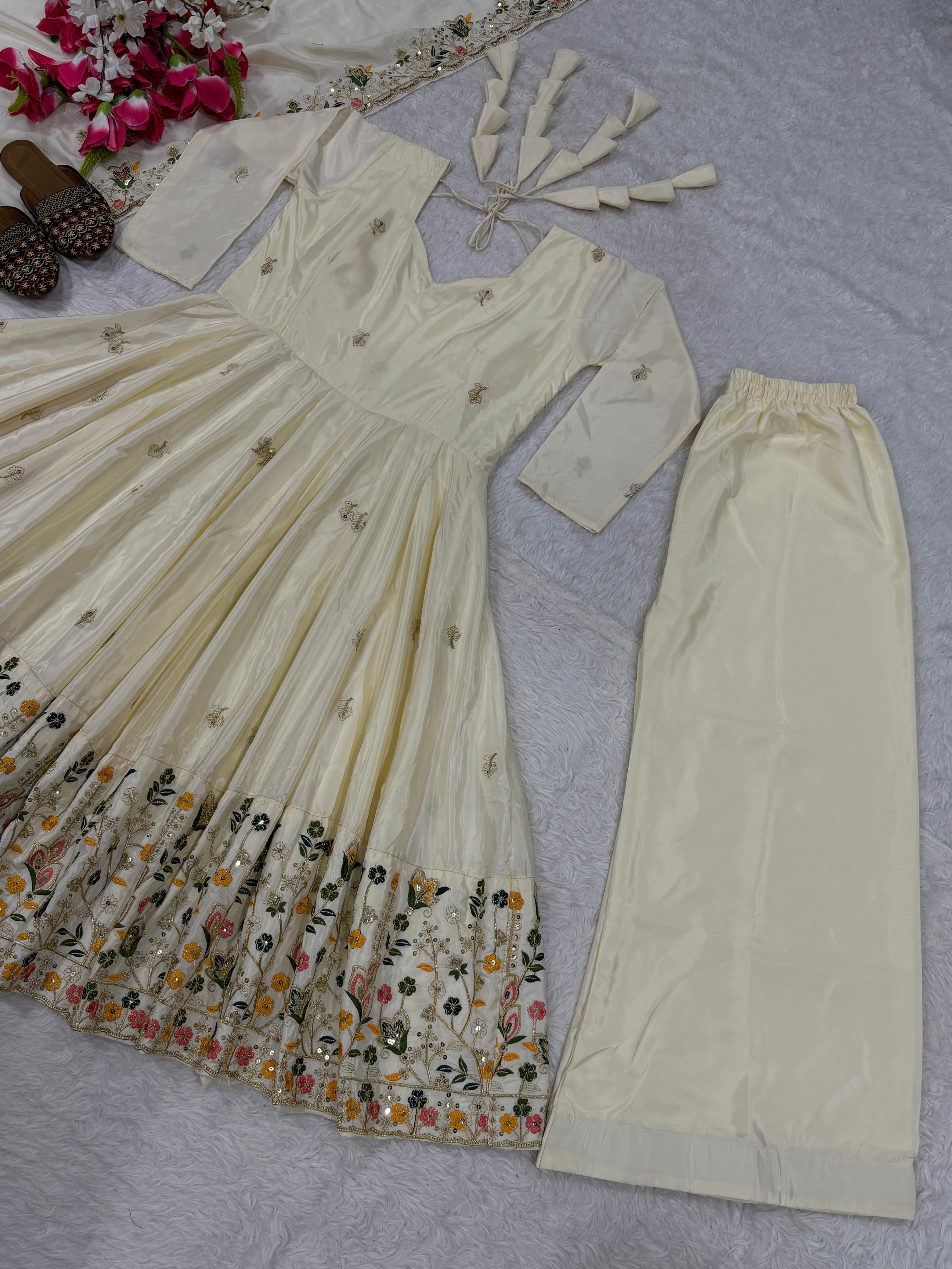 Beige traditional outfit with floral embroidery on a light gray surface.