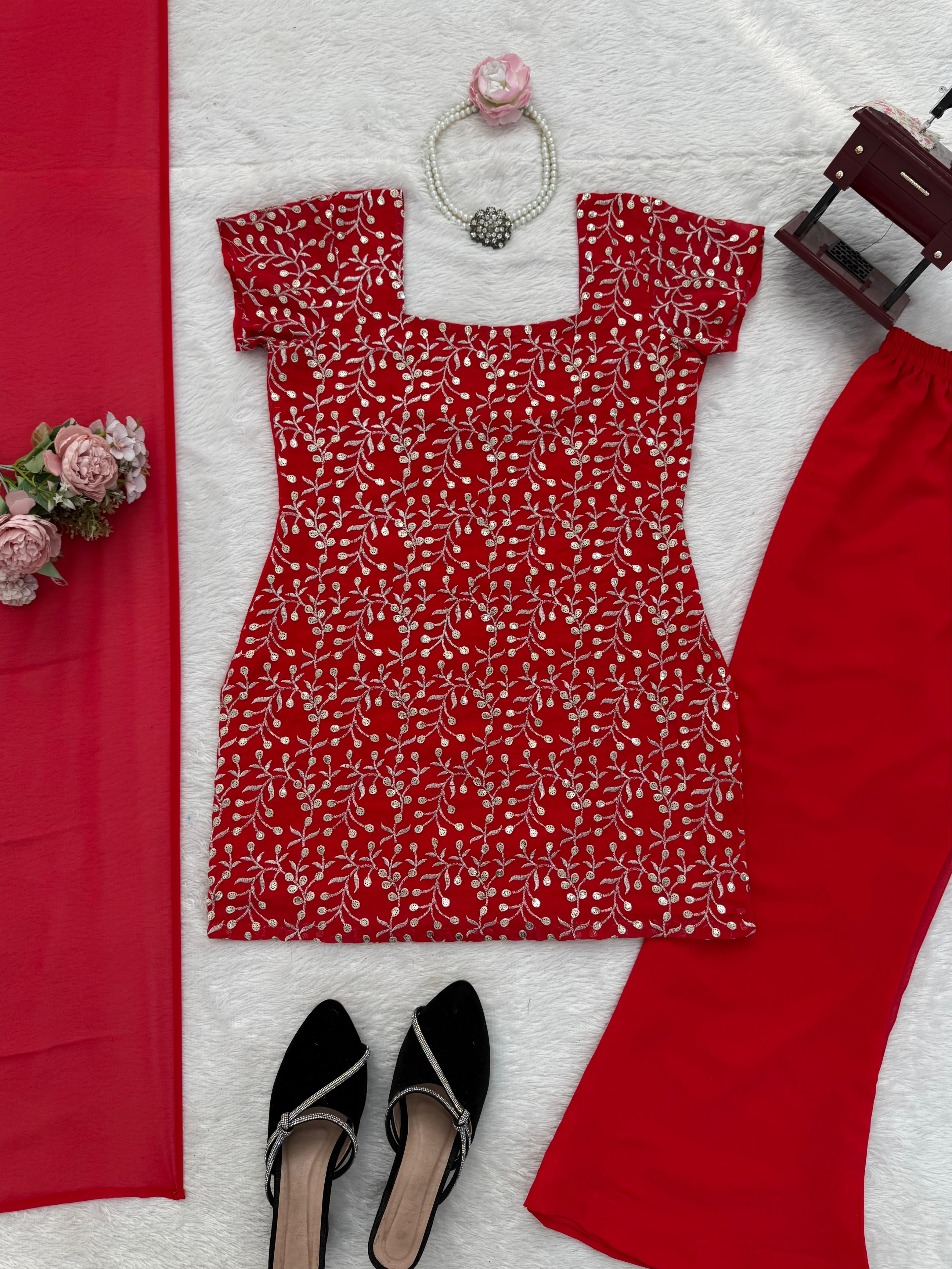 Red patterned dress with black shoes, handbag, and flowers on a white and red background