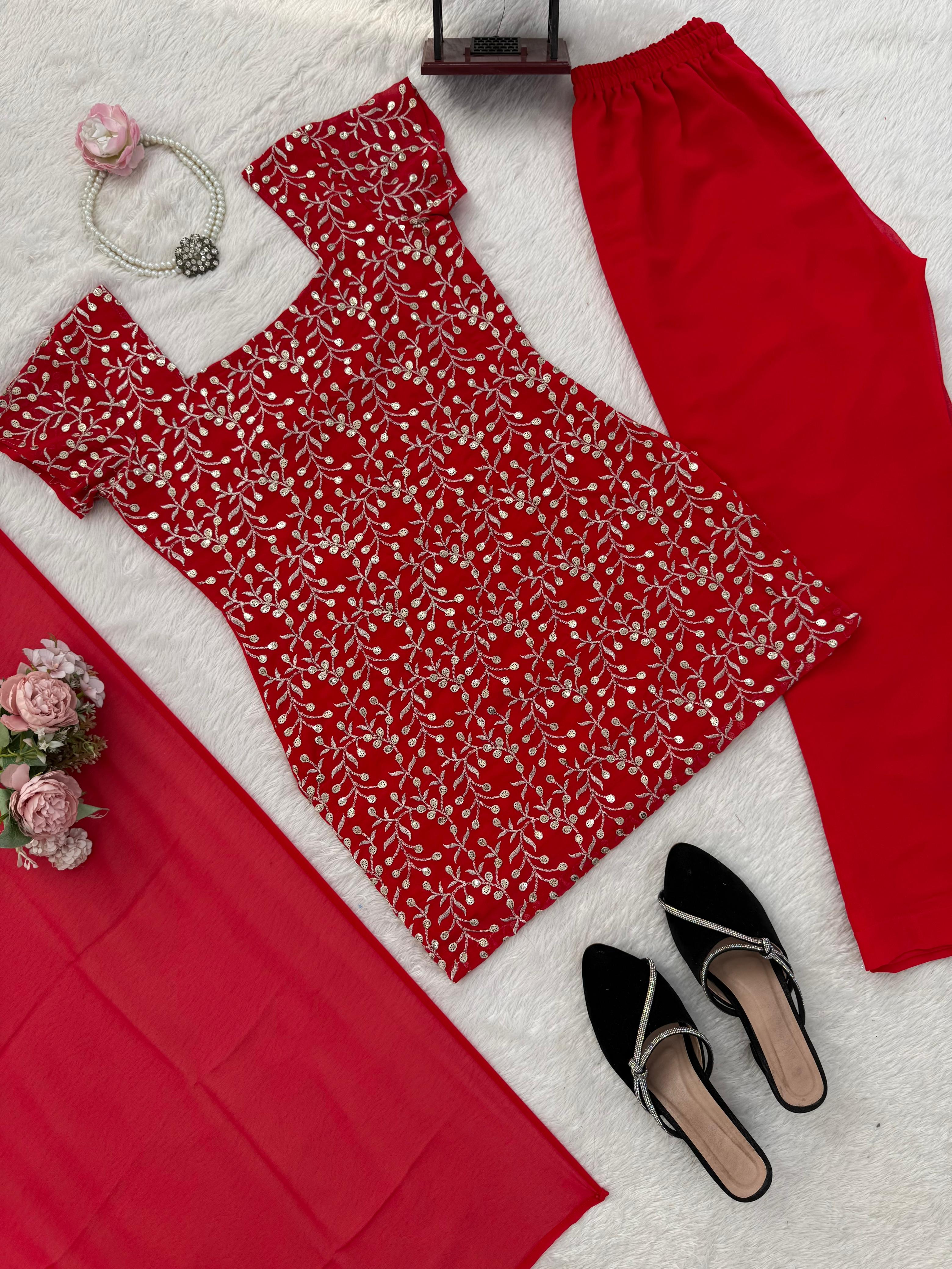 Red floral dress with matching pants, black sandals, and jewelry on a white background