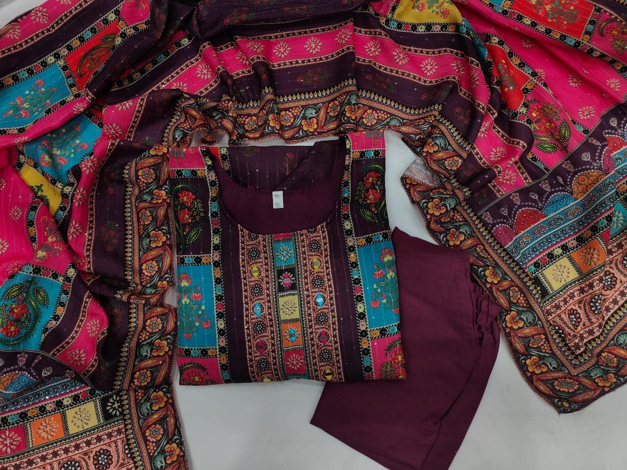 Colorful traditional fabric with intricate patterns on a white background