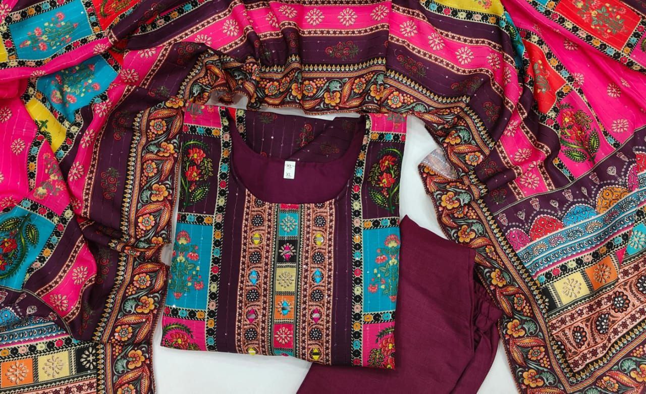 Colorful embroidered fabric with a maroon garment underneath on a white background
