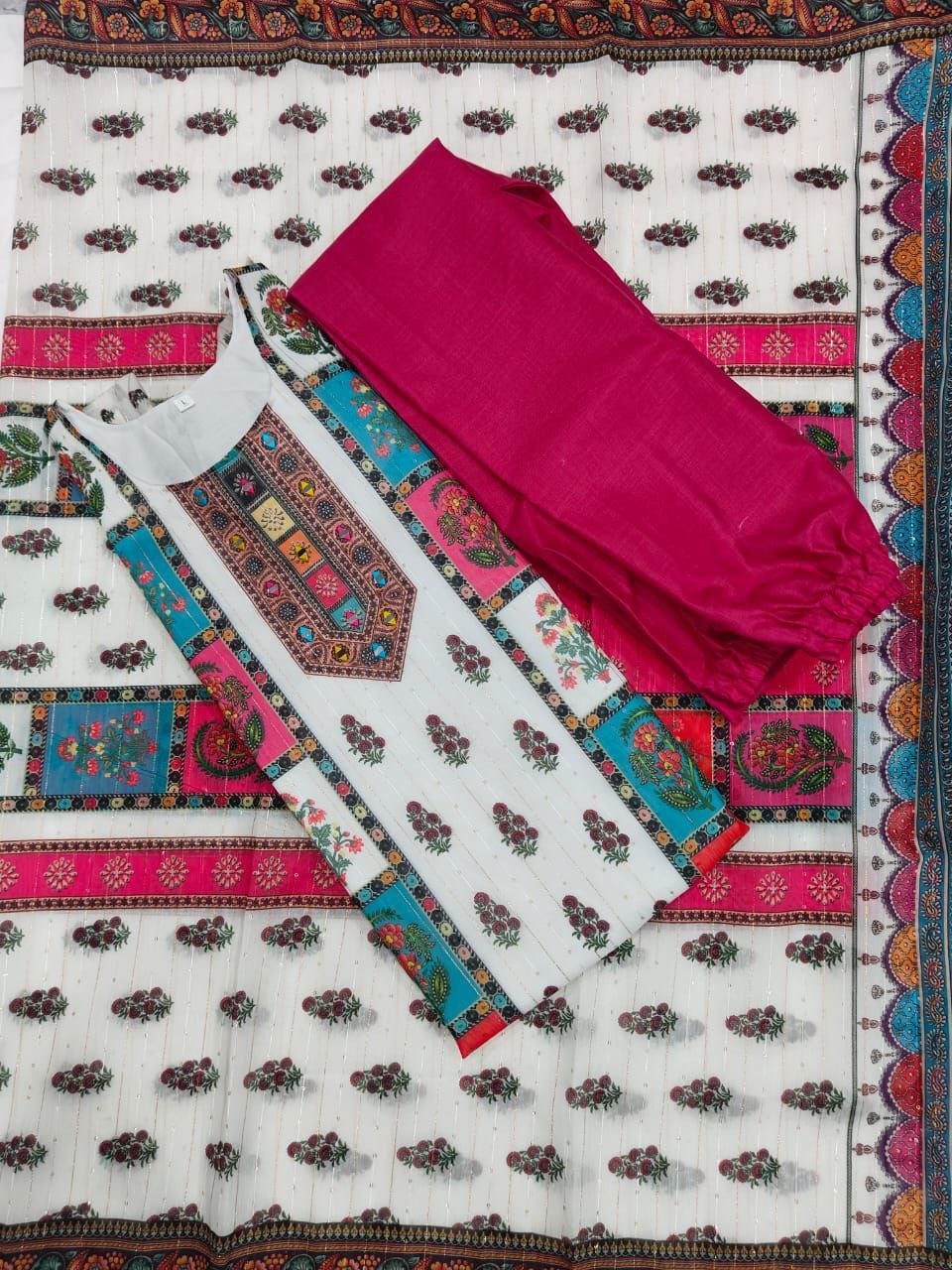 Traditional outfit with a white dress and pink dupatta on a patterned fabric background