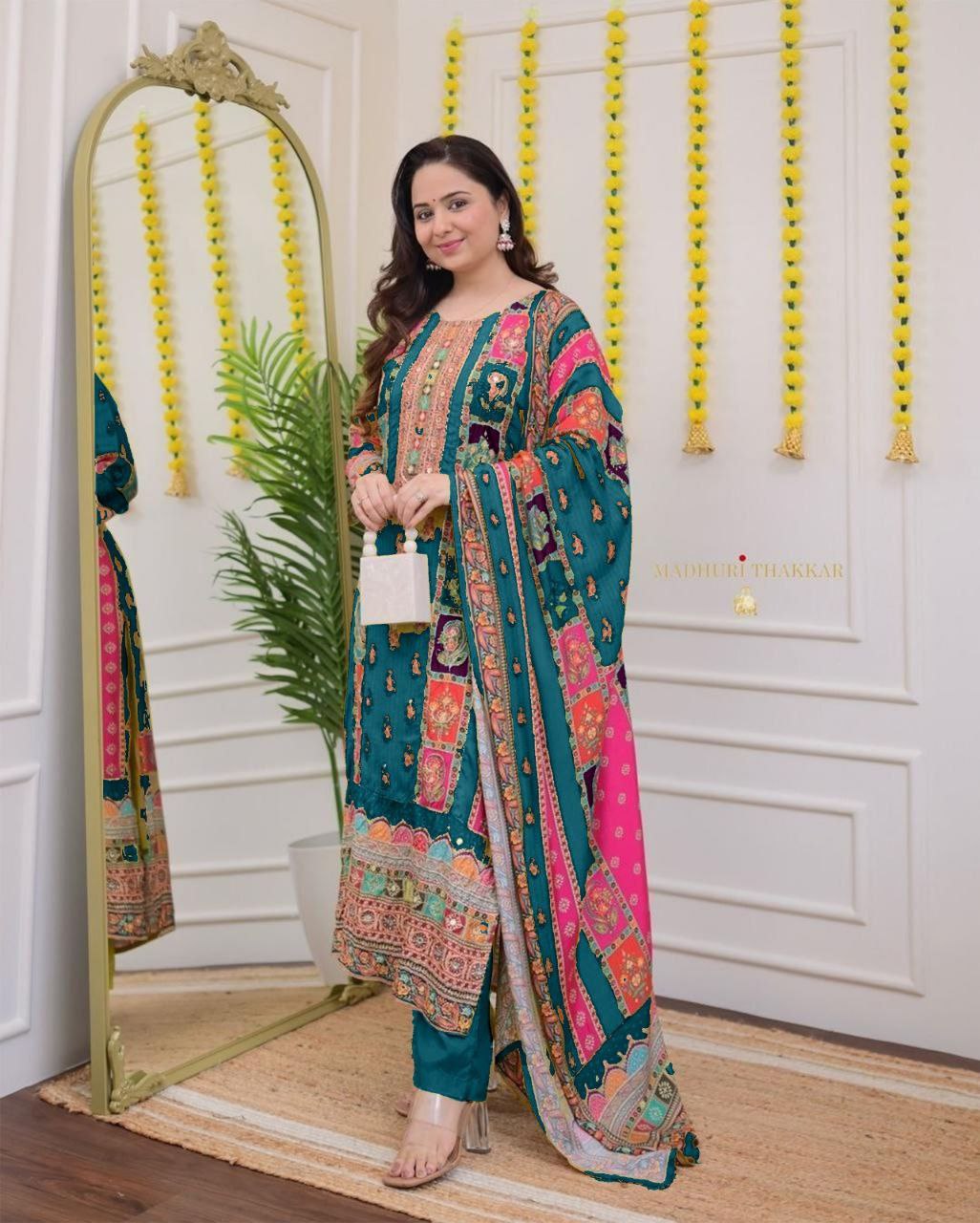 Woman in a colorful traditional outfit standing in front of a mirror.