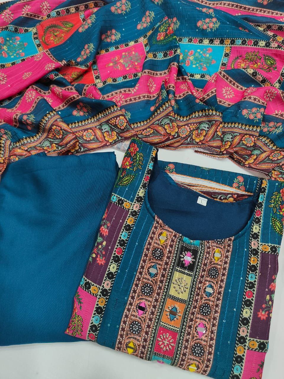 Colorful embroidered fabric with a blue base on a white background